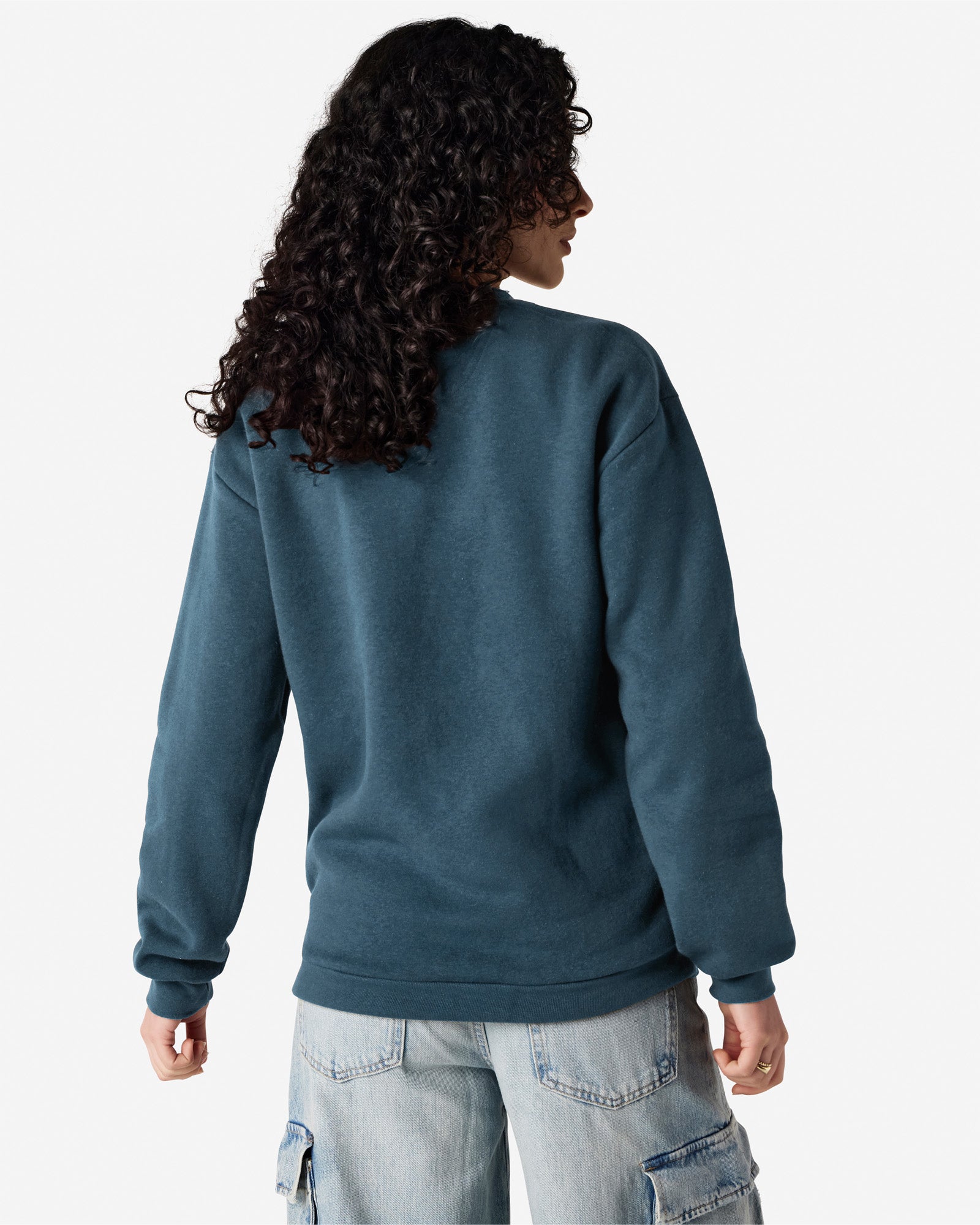 Female model wearing a Reflex Unisex Crewneck Sweatshirt (back pose) -sea blue