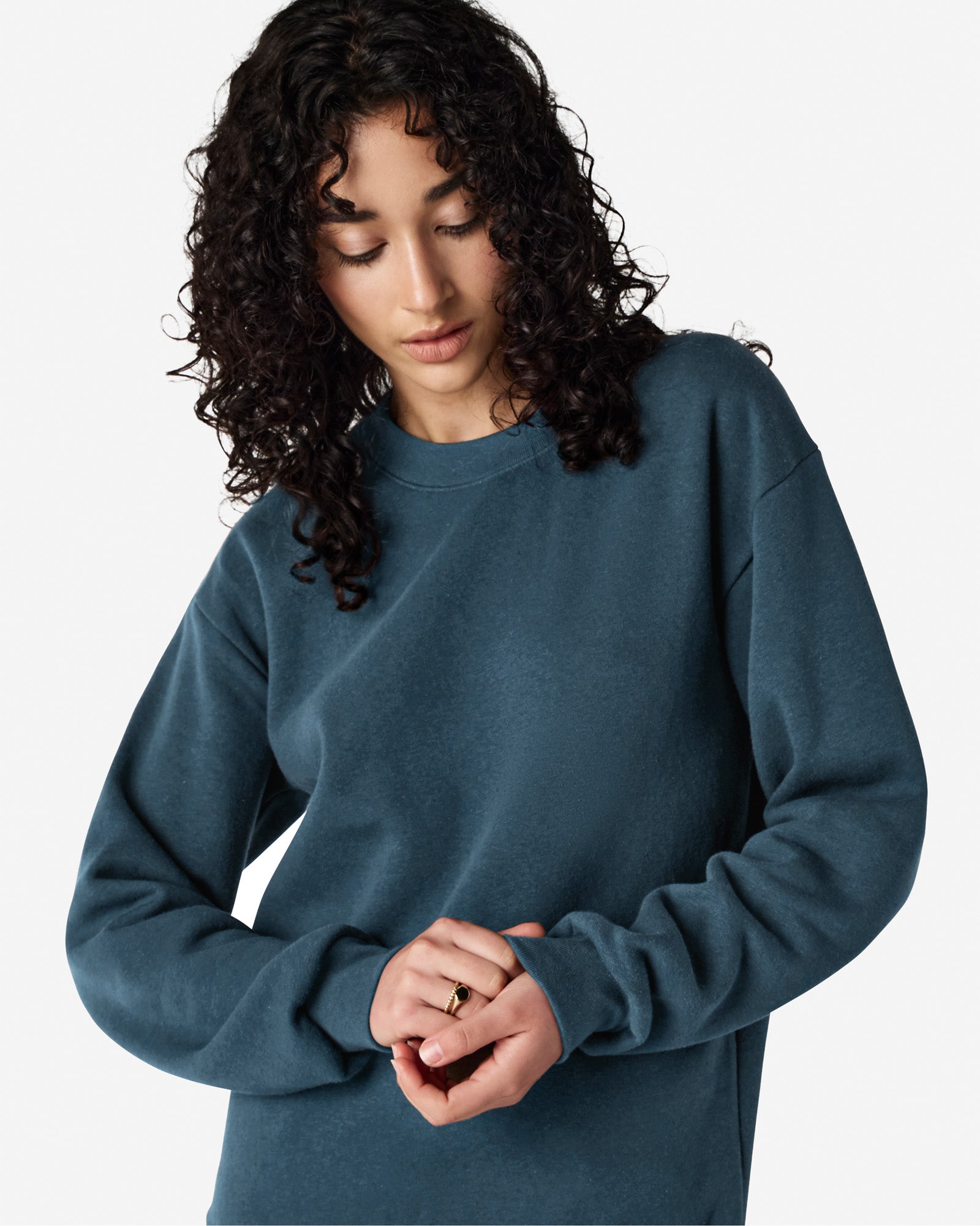 Female model wearing a Reflex Unisex Crewneck Sweatshirt (front pose) -sea blue