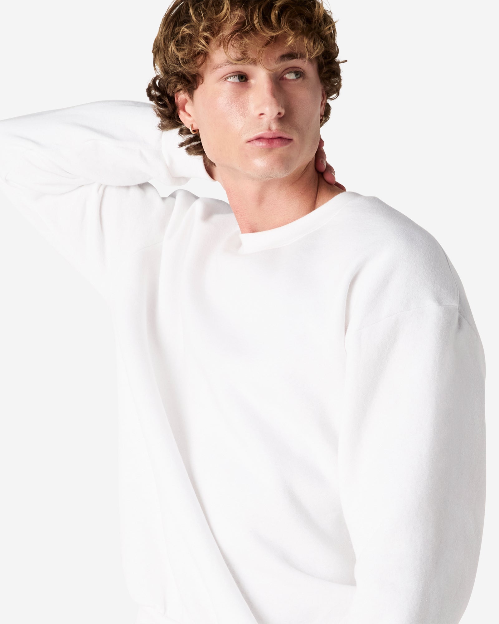 Male model wearing a Reflex Unisex Crewneck Sweatshirt (front pose) -white