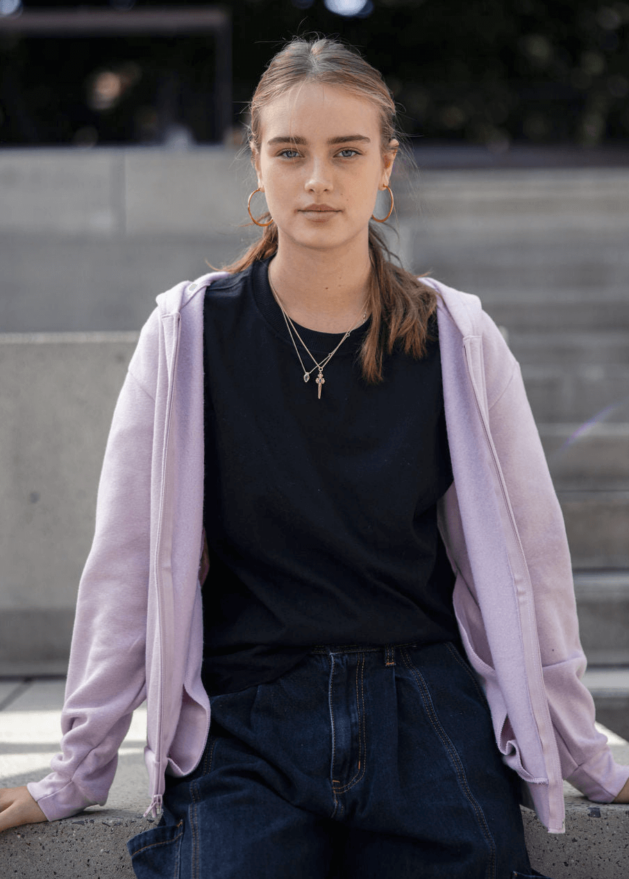 Male model wearing Reflex Unisex Full Zip Hooded Sweatshirt pairing with black jeans (front pose) -blush