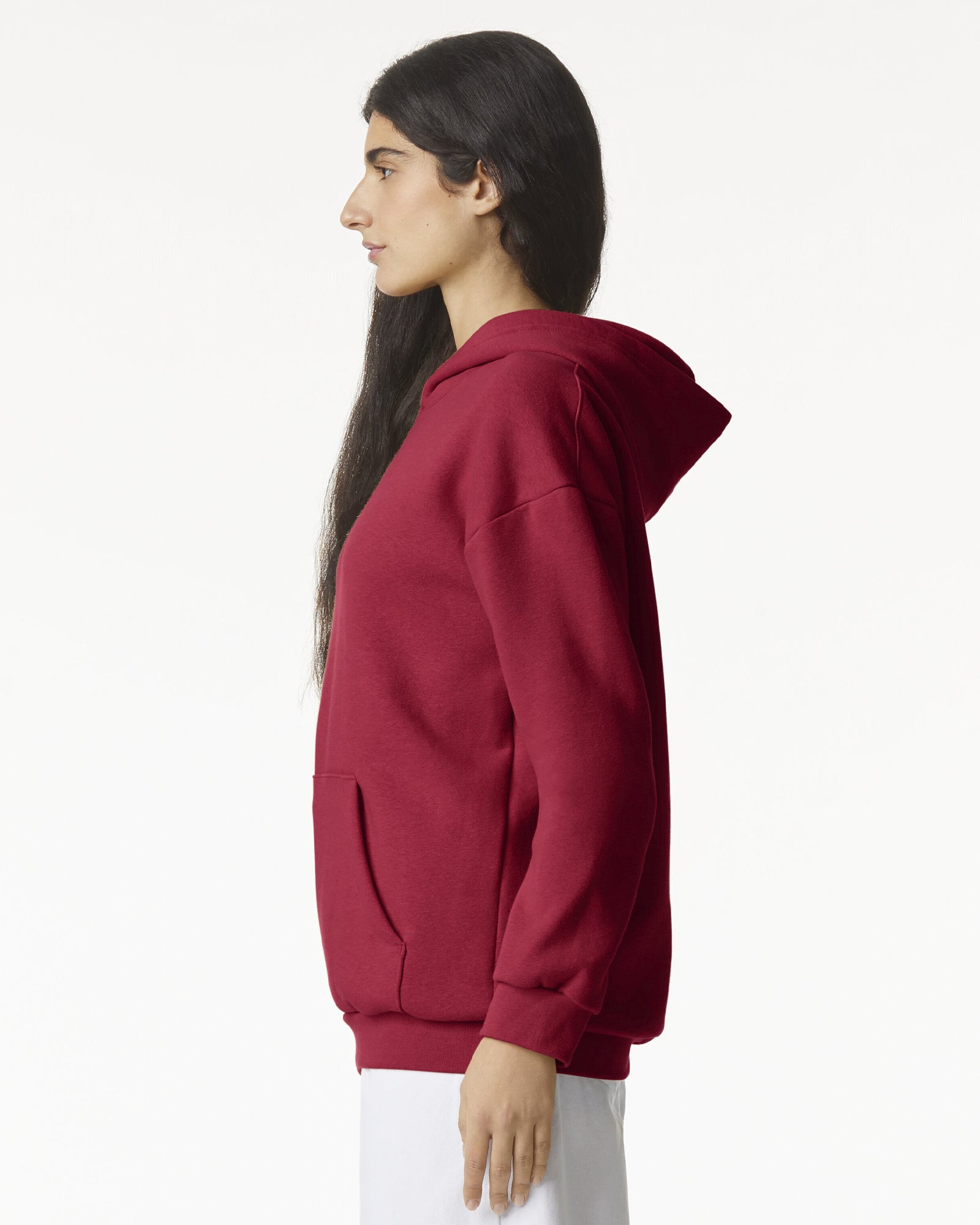 Female model wearing a Reflex Unisex Hooded Sweatshirt (side pose) -cardinal red