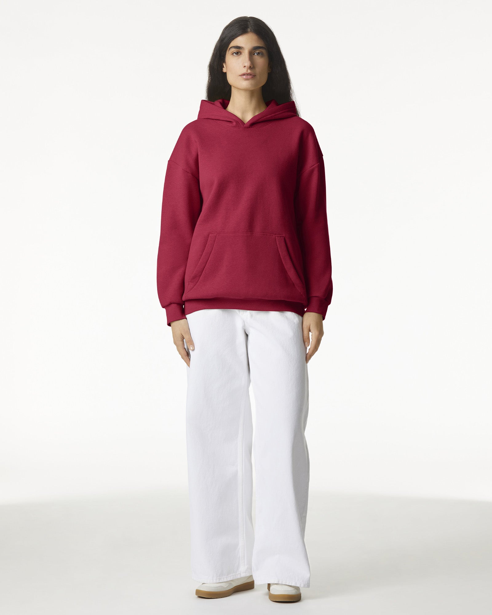 Female model wearing a Reflex Unisex Hooded Sweatshirt (front pose) -cardinal red