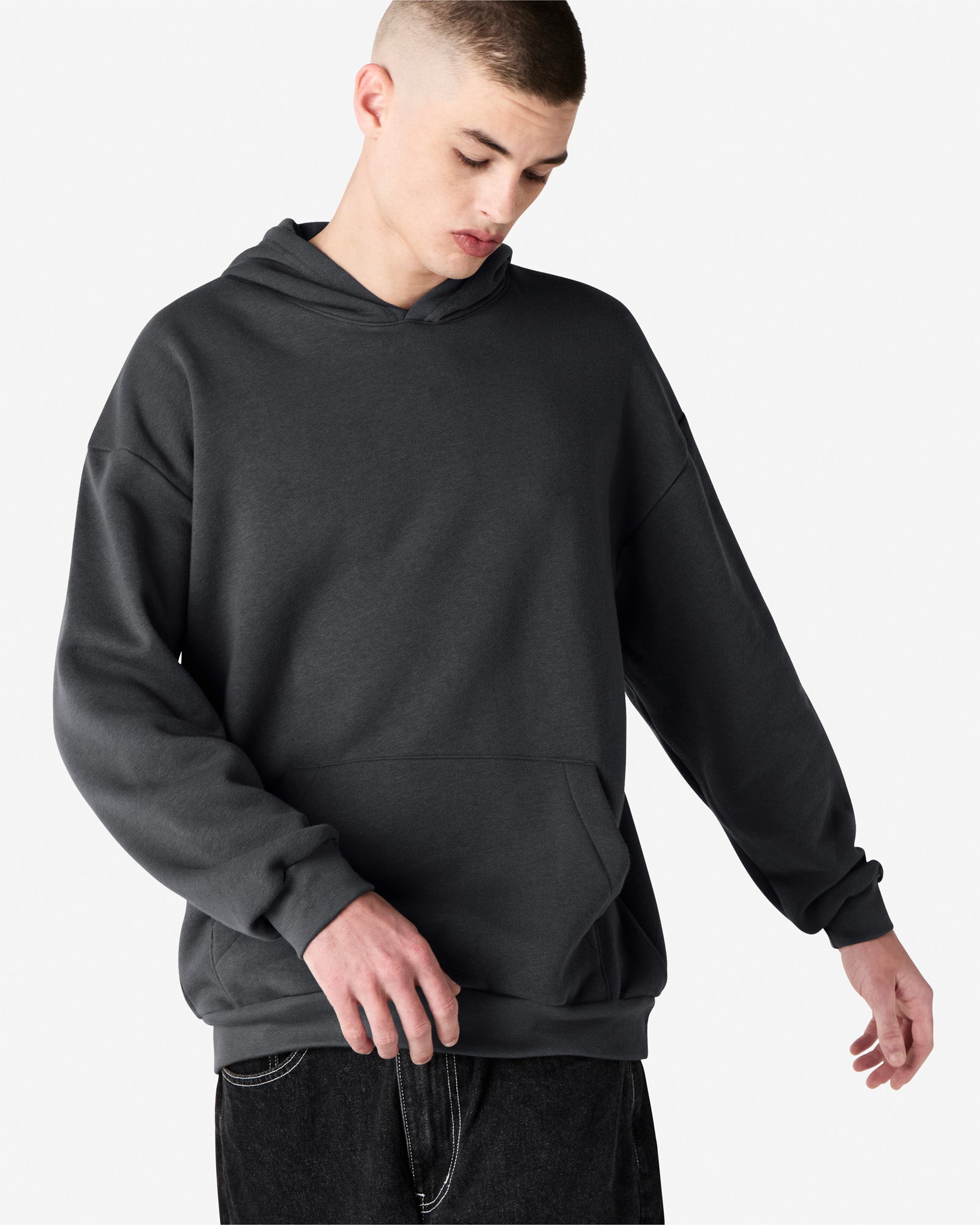 Male model wearing a Reflex Unisex Hooded Sweatshirt (front pose) -asphalt