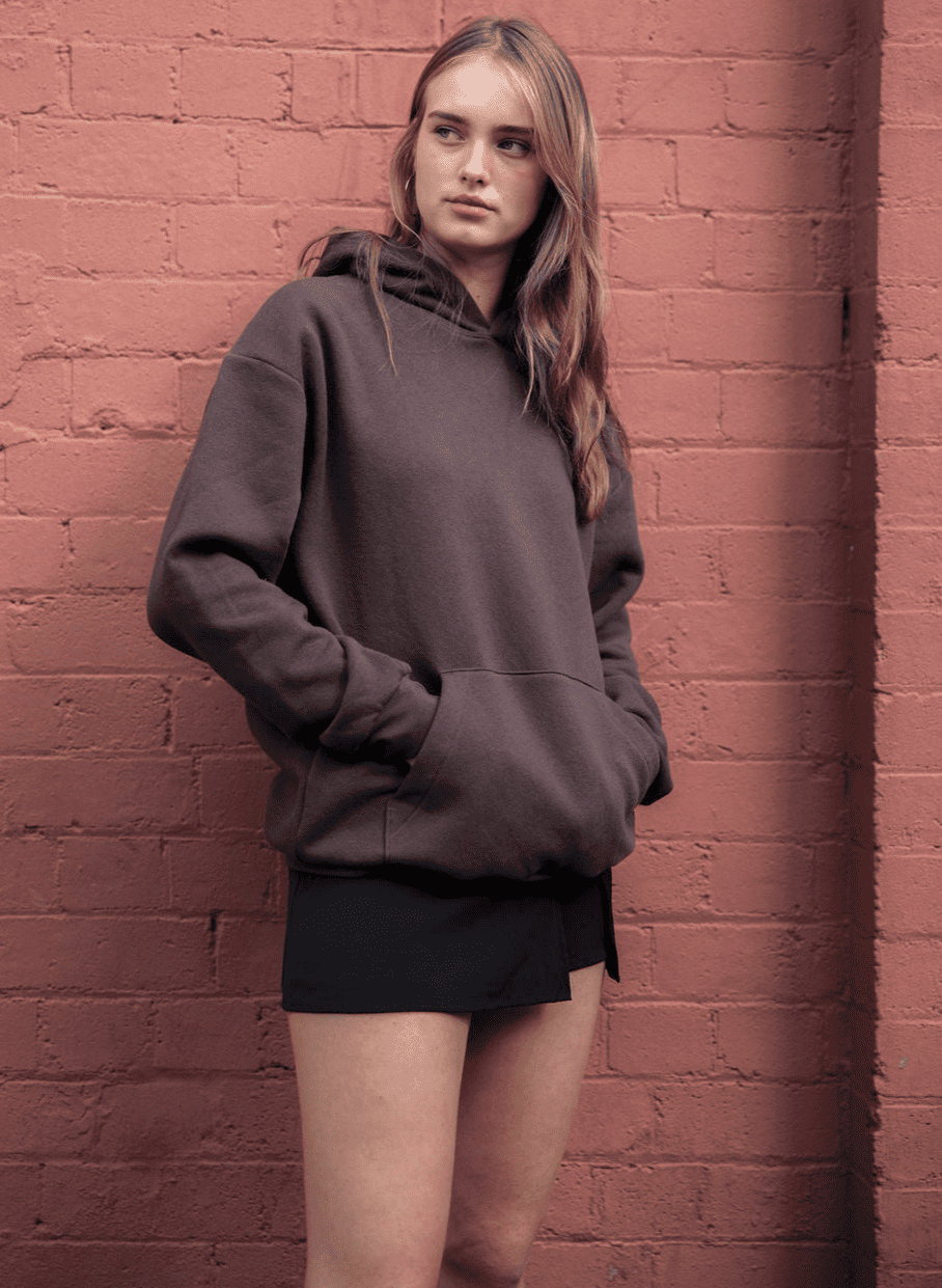 Male model wearing a Reflex Unisex Hooded Sweatshirt (front pose) -Brown