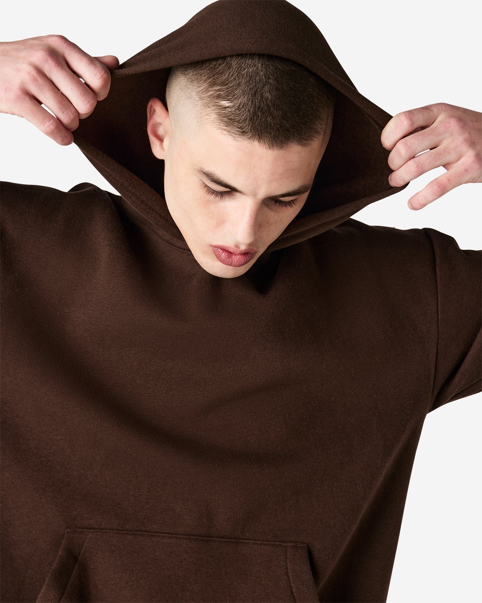 Male model wearing a Reflex Unisex Hooded Sweatshirt (front pose) -brown