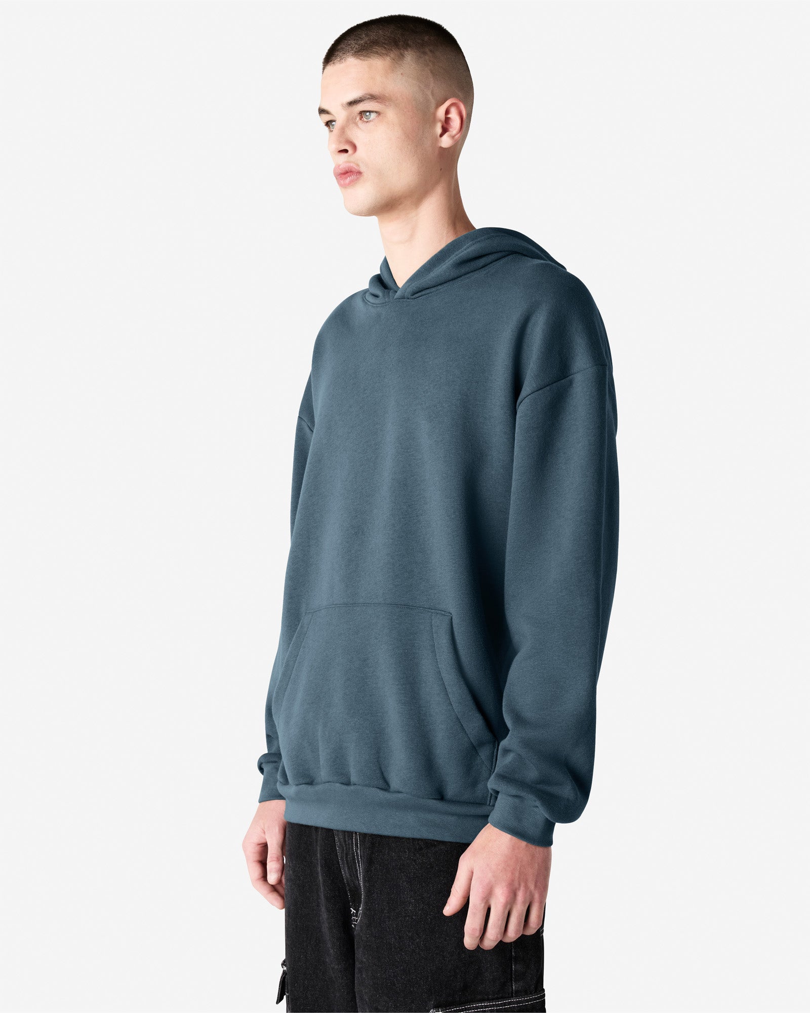 Male model wearing a Reflex Unisex Hooded Sweatshirt (side pose) -sea blue