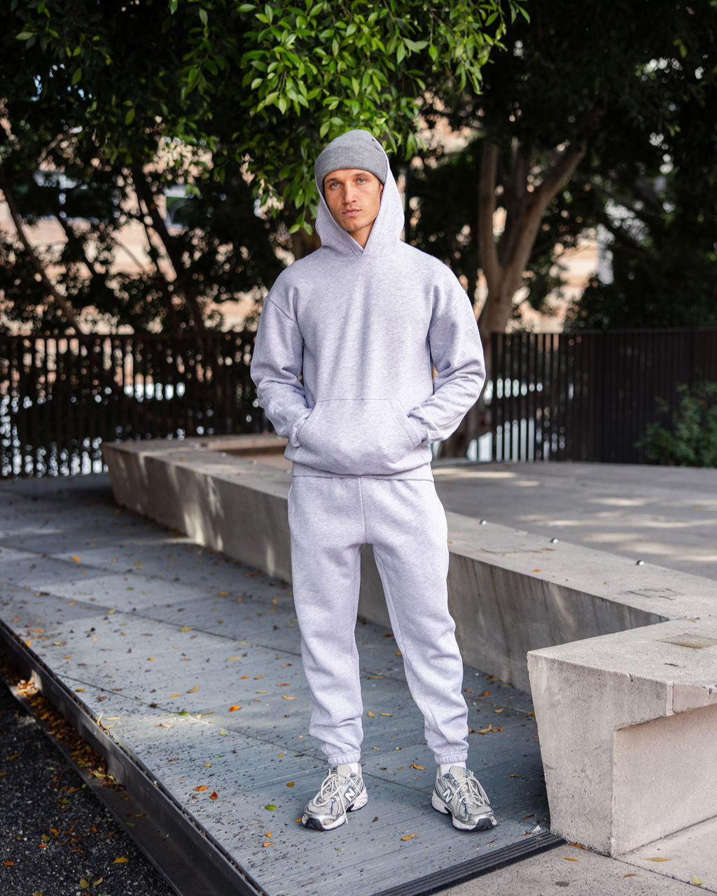 Male model wearing a Reflex Unisex Hooded Sweatshirt (full body pose) -heather grey