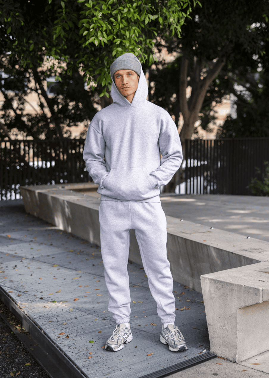 Male model wearing a Reflex Unisex Hooded Sweatshirt (full body pose) -heather grey