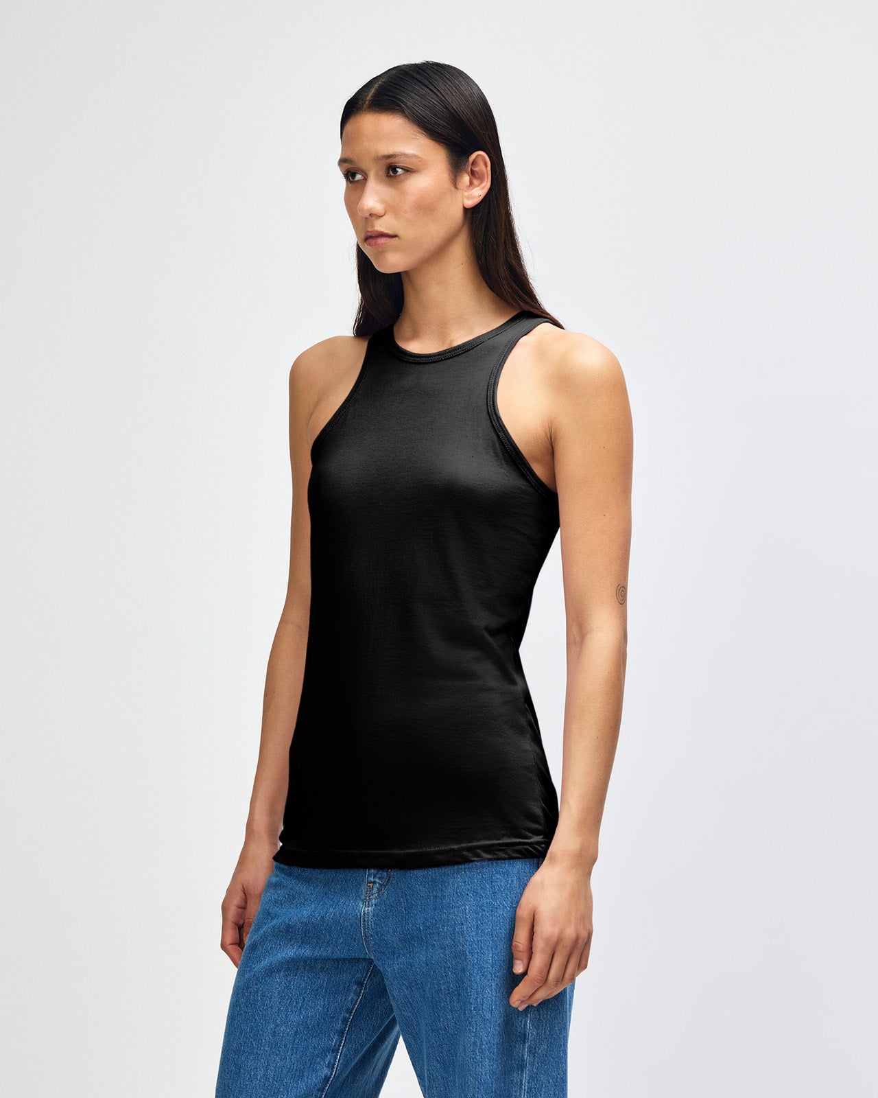 Female model wearing black colour American Apparel Fine Jersey Unisex Tank Top (front pose) -black