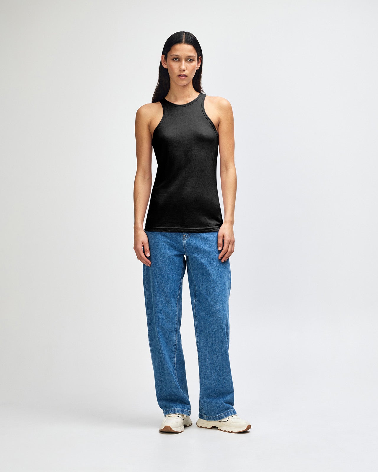 Female model wearing black colour American Apparel Fine Jersey Unisex Tank Top (front pose) -black