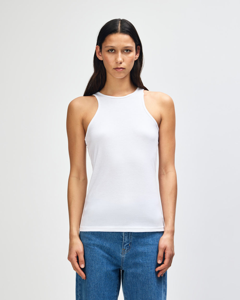 image of Women's Racer Neck Tank : Female model wearing white colour American Apparel Fine Jersey Unisex Tank Top (front pose) -white