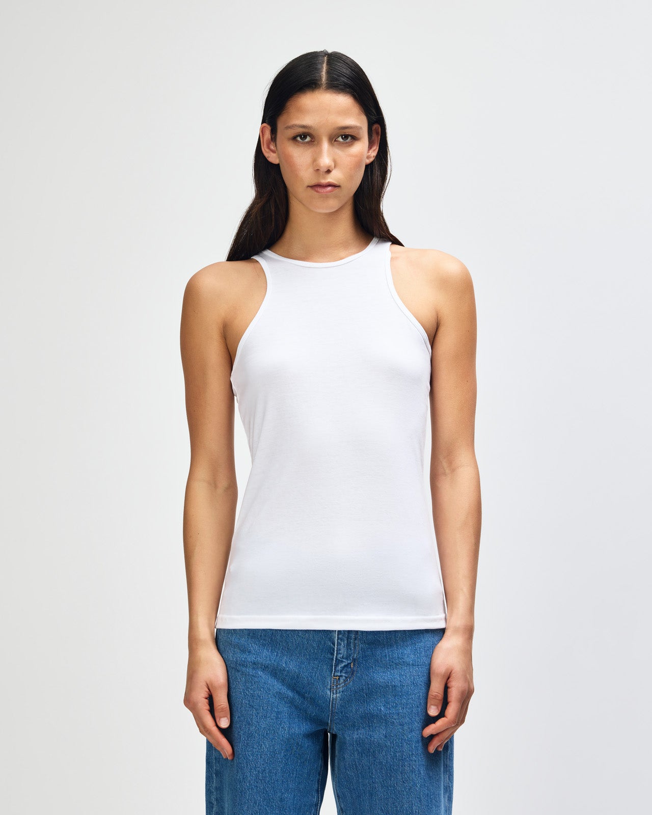 Female model wearing white colour American Apparel Fine Jersey Unisex Tank Top (front pose) -white