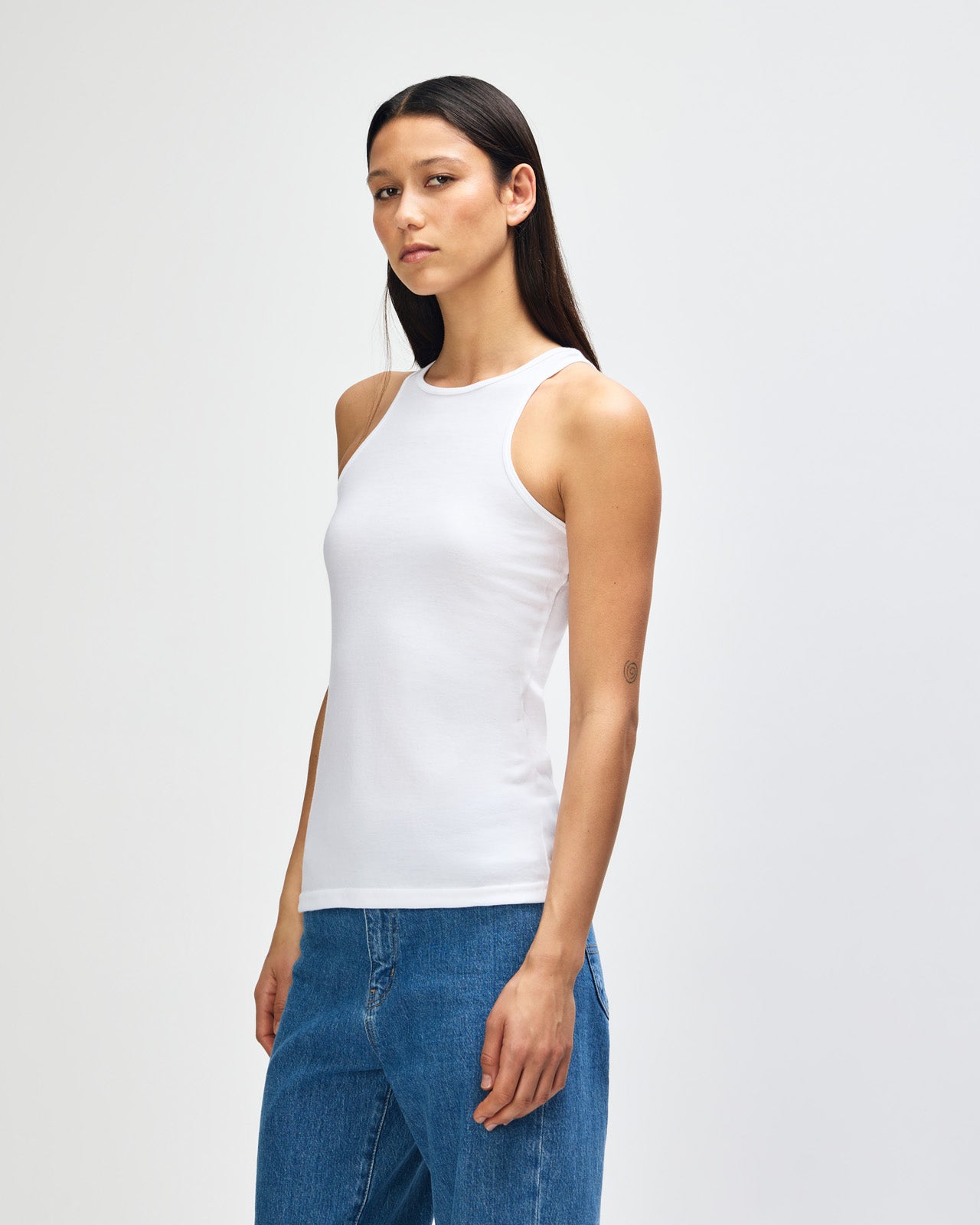 Female model wearing white colour American Apparel Fine Jersey Unisex Tank Top (front pose) -white