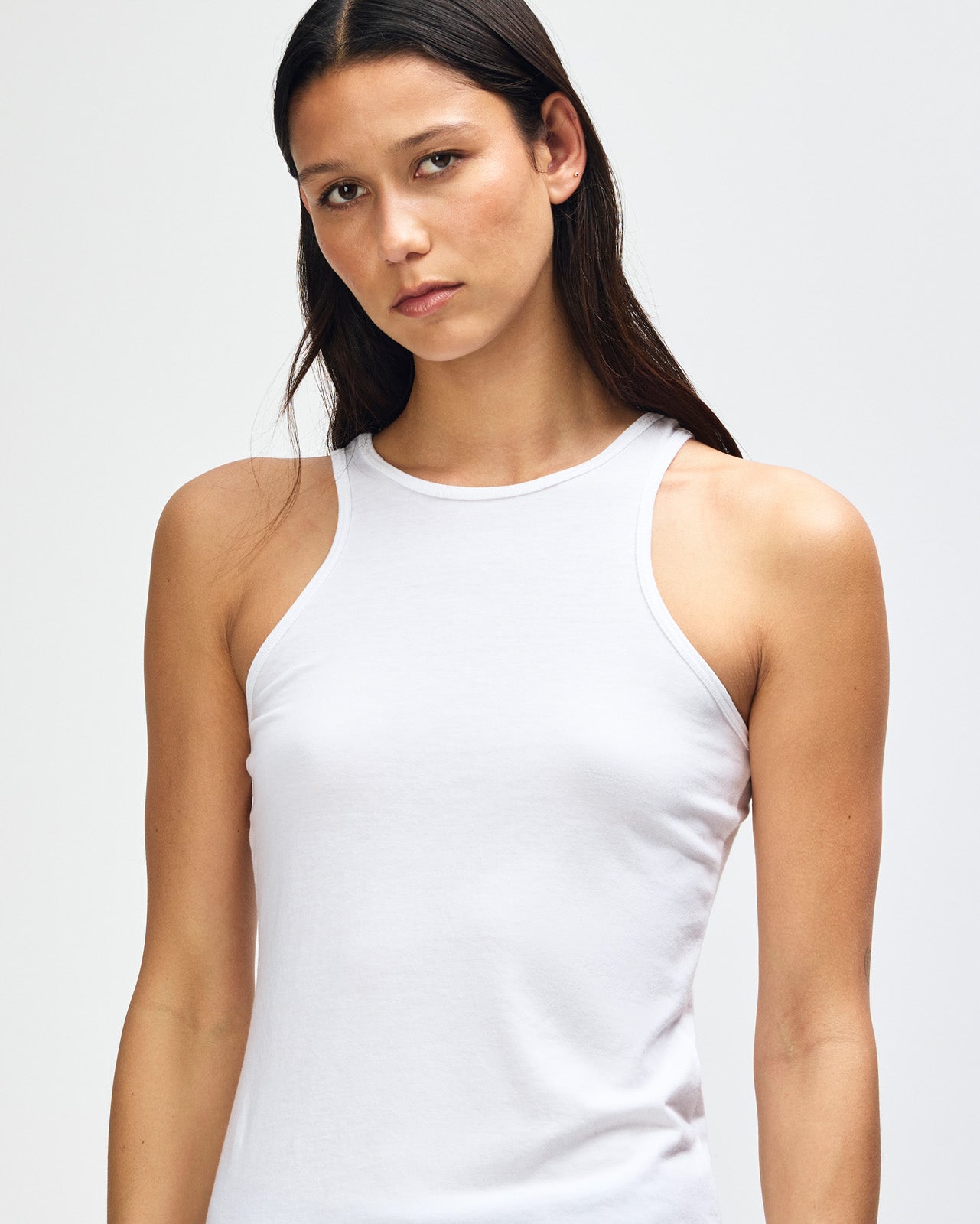 Female model wearing white colour American Apparel Fine Jersey Unisex Tank Top (front pose) -white
