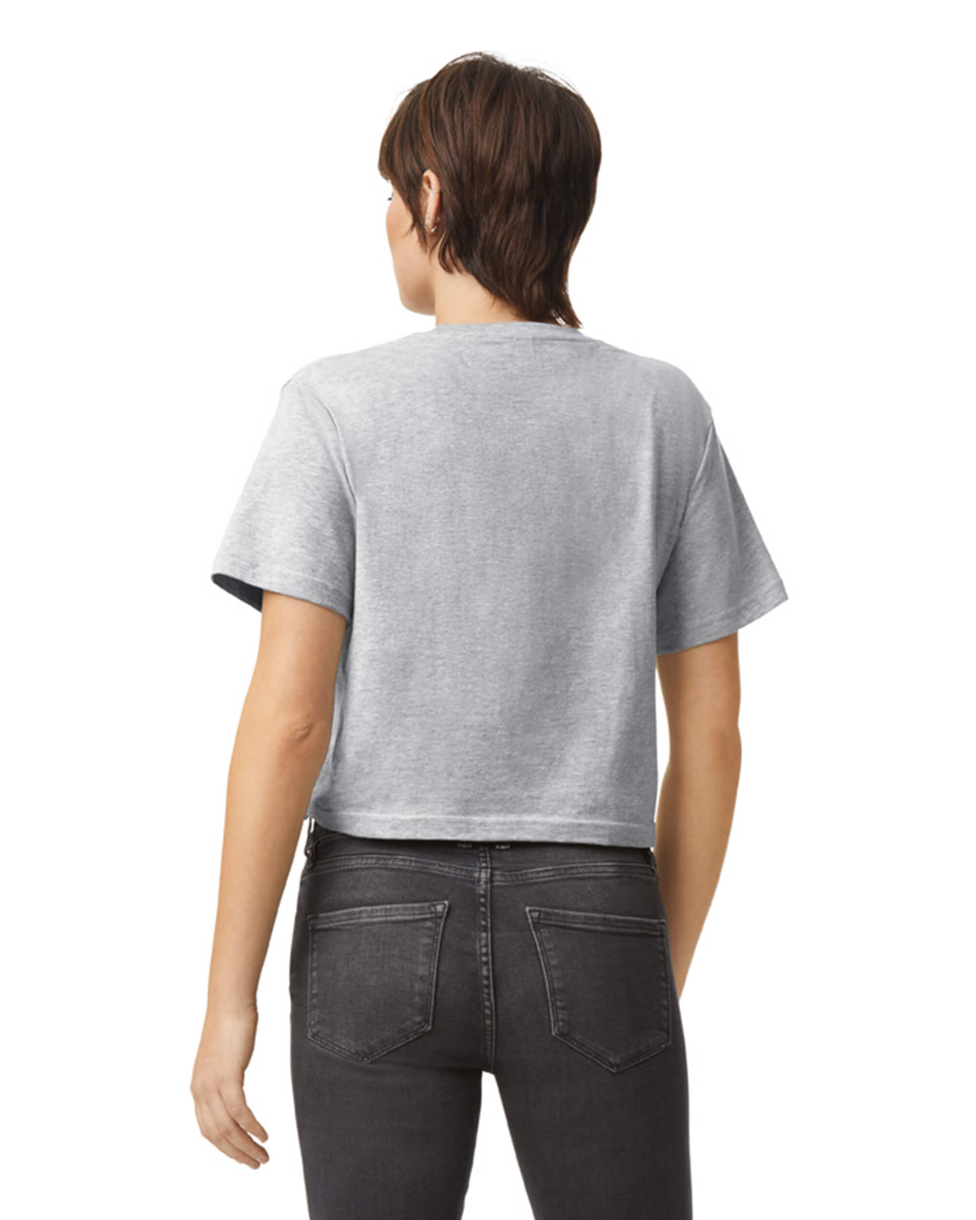 Female model wearing an American Apparel Fine Jersey Women's Boxy Tee in Heather Sport Grey, paired with black jeans, standing against a plain background (back pose) -heather grey