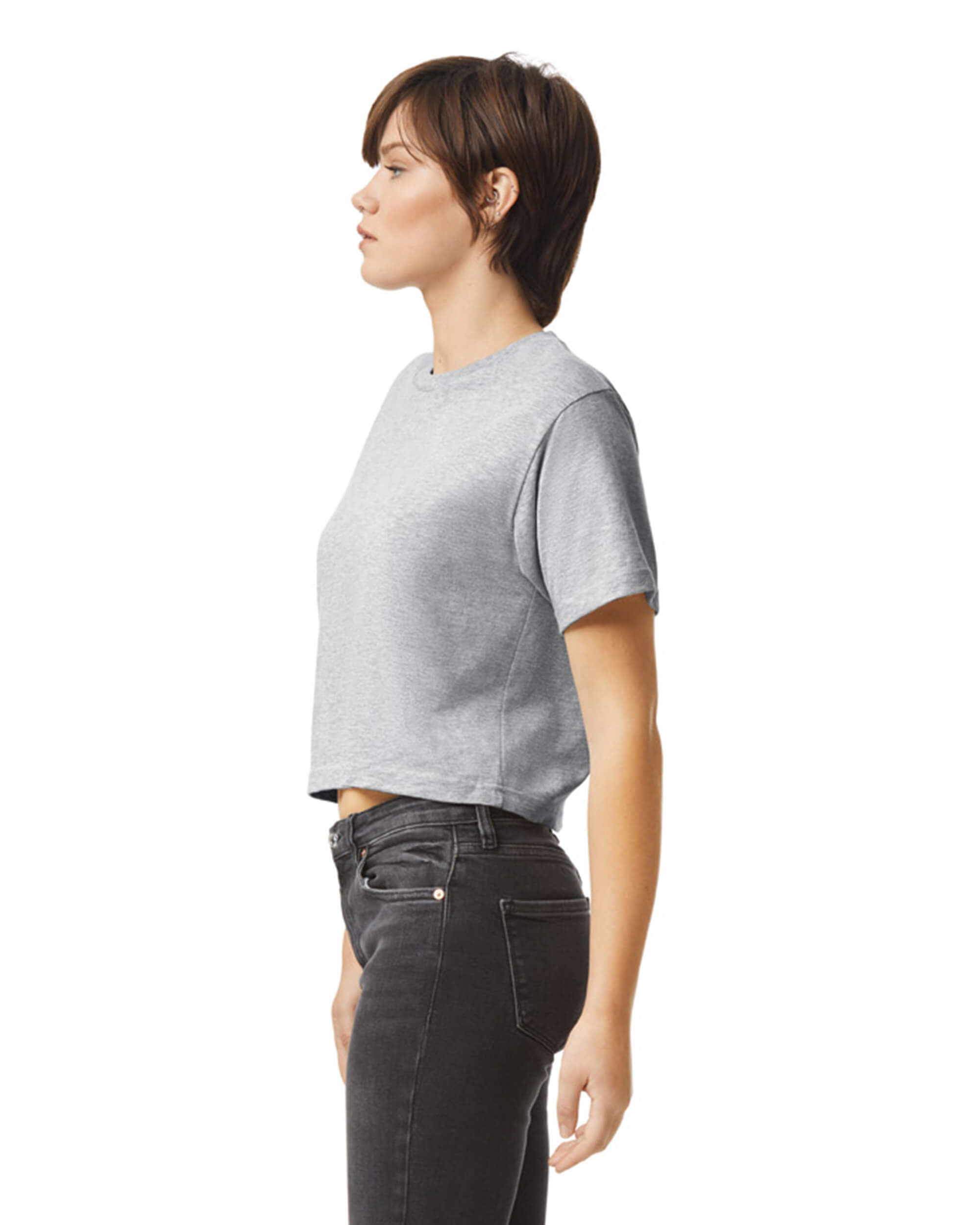 Female model wearing an American Apparel Fine Jersey Women's Boxy Tee in Heather Sport Grey, paired with black jeans, standing against a plain background (front pose) -heather grey