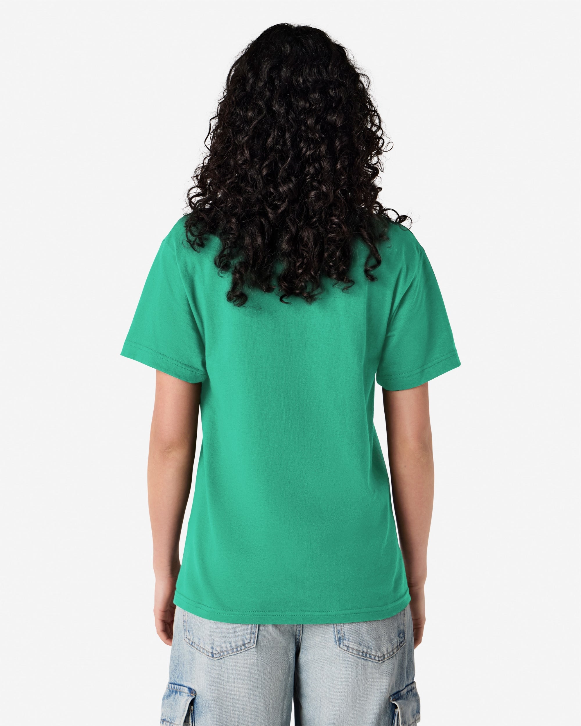 Female Model wearing a Celadon Heavyweight Unisex Short Sleeve Crew Neck Tee, paired with blue jeans, standing against a plain background (back pose) -celadon