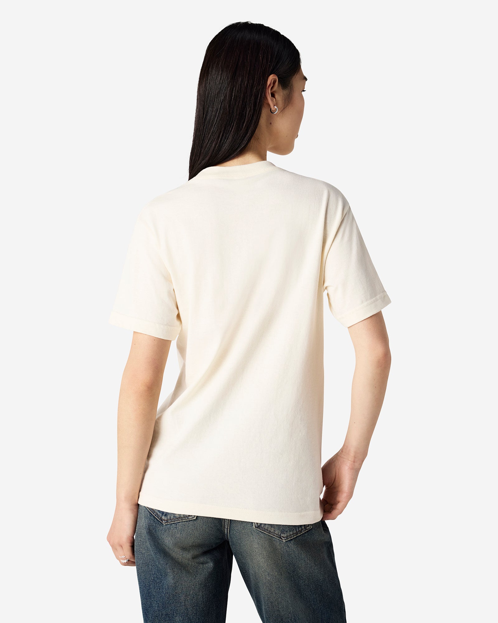 Male Model wearing a Cream Heavyweight Unisex Short Sleeve Crew Neck Tee, paired with blue jeans, standing against a plain background (front pose) -cream