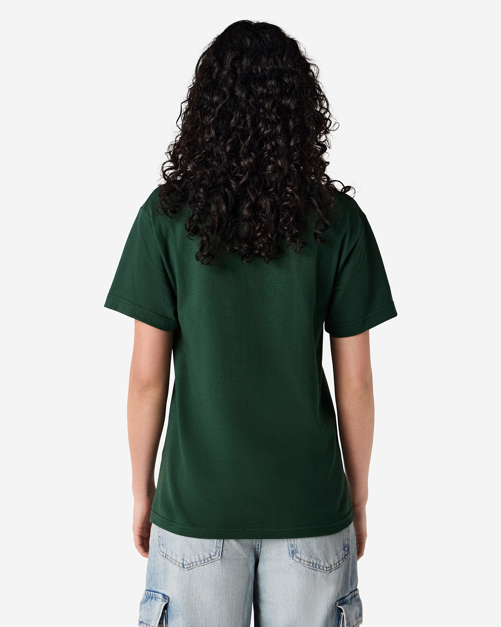 Female Model wearing a Forest Heavyweight Unisex Short Sleeve Crew Neck Tee, paired with blue jeans, standing against a plain background (back pose) -forest green