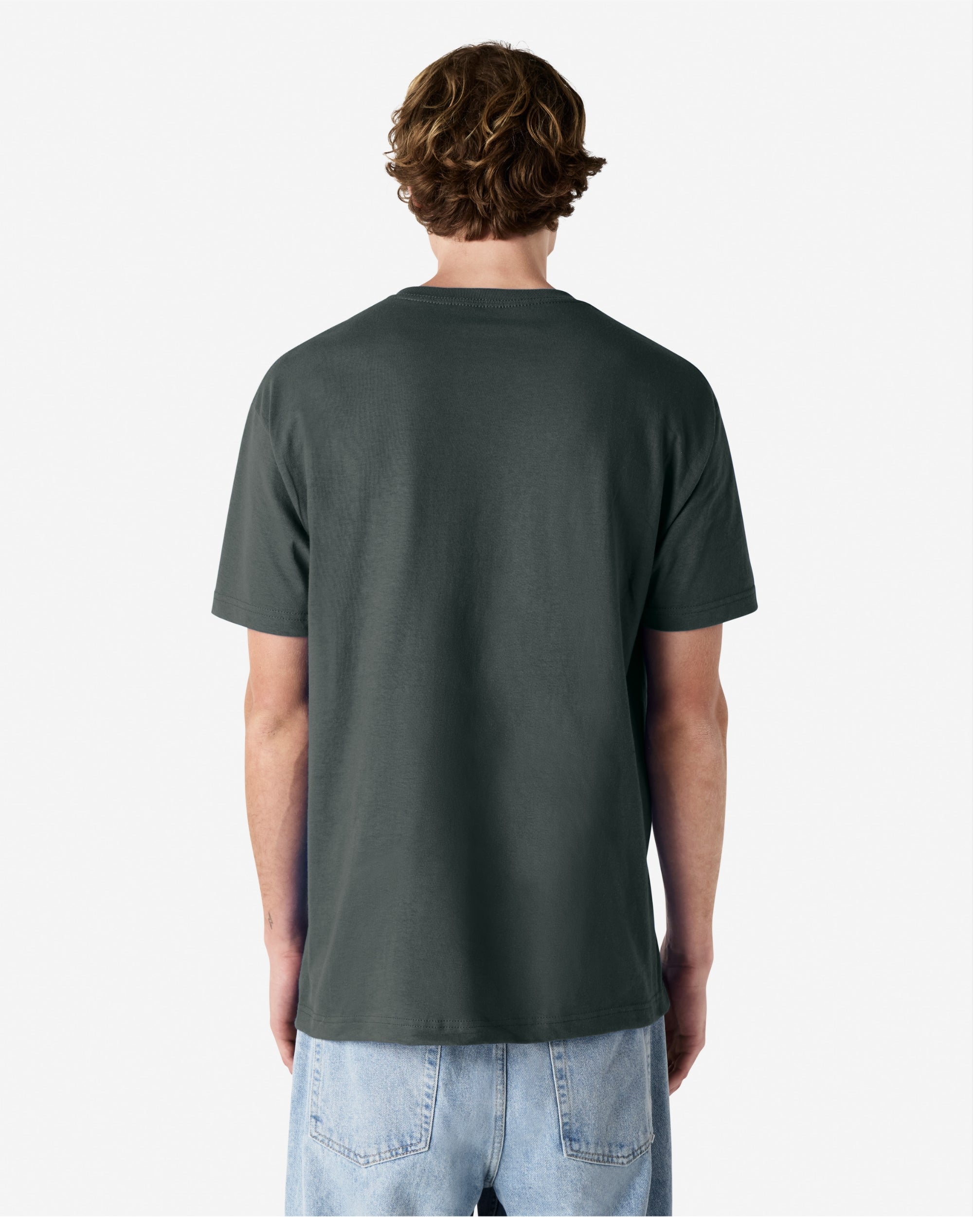 Male Model wearing a Heather Charcoal Heavyweight Unisex Short Sleeve Crew Neck Tee, paired with blue jeans, standing against a plain background (back pose) -heather charcoal