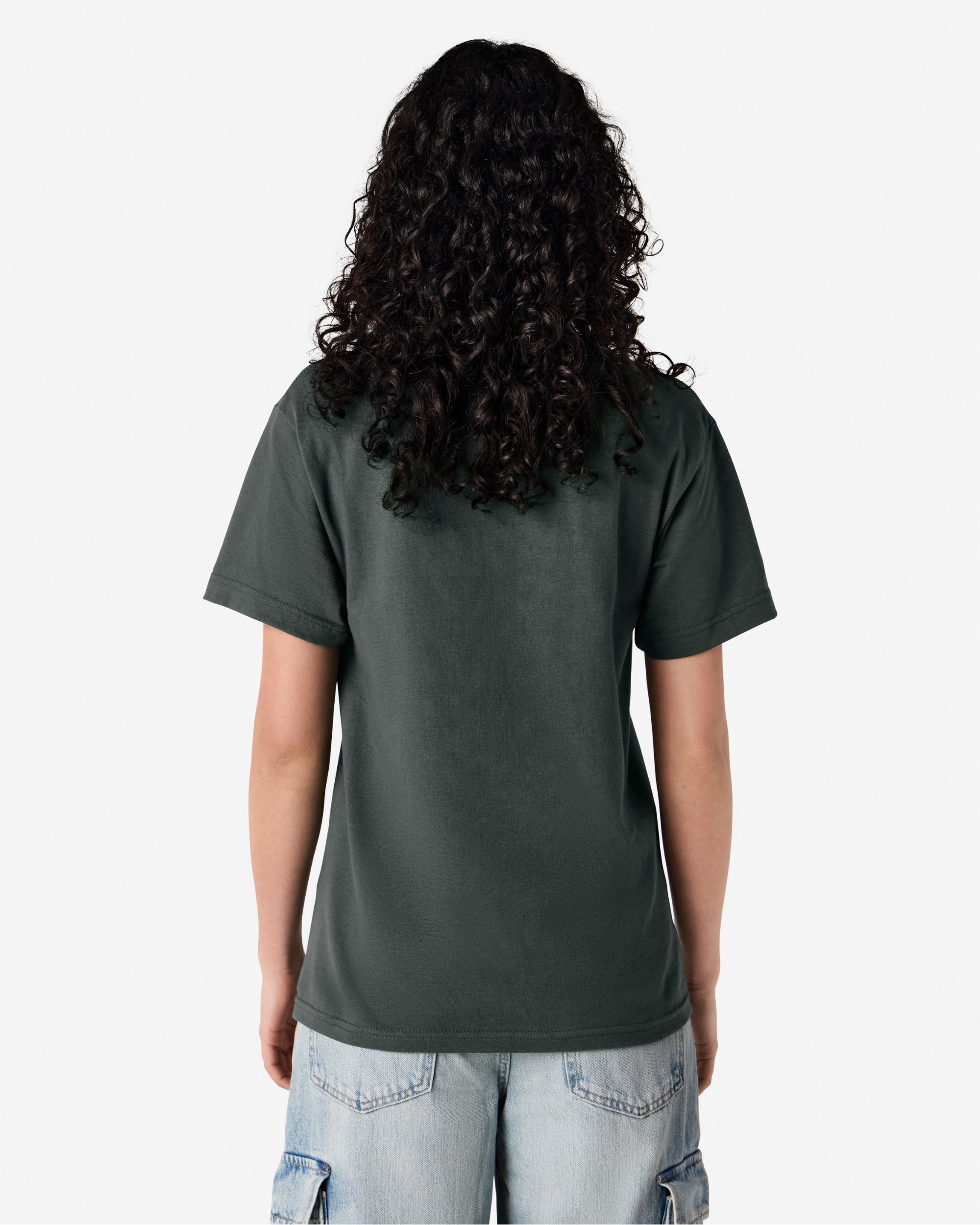 Feamle Model wearing a Heather Charcoal Heavyweight Unisex Short Sleeve Crew Neck Tee, paired with blue jeans, standing against a plain background (back pose) -heather charcoal