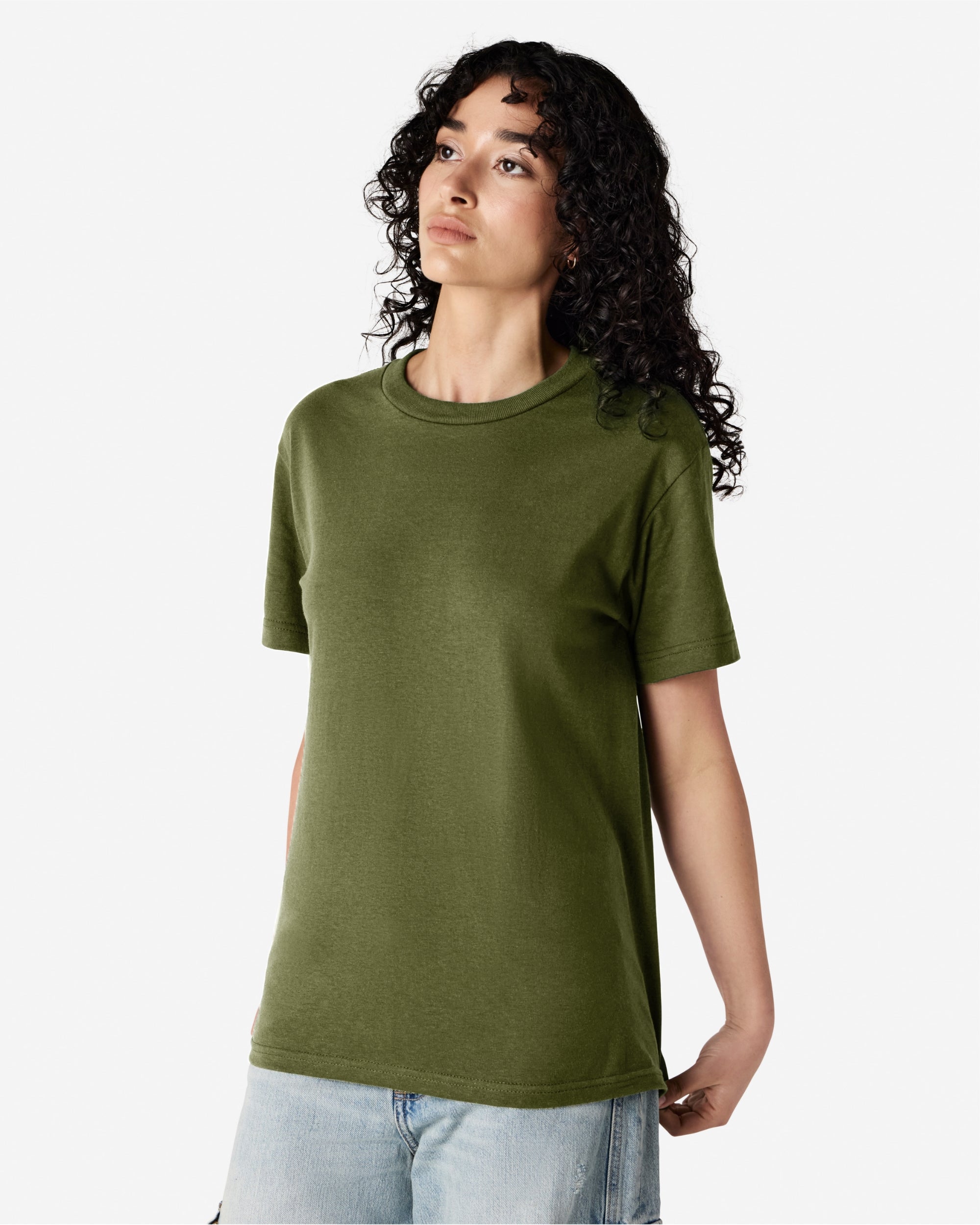 Female Model wearing a Military Green Heavyweight Unisex Short Sleeve Crew Neck Tee, paired with blue jeans, standing against a plain background (front pose) -military green