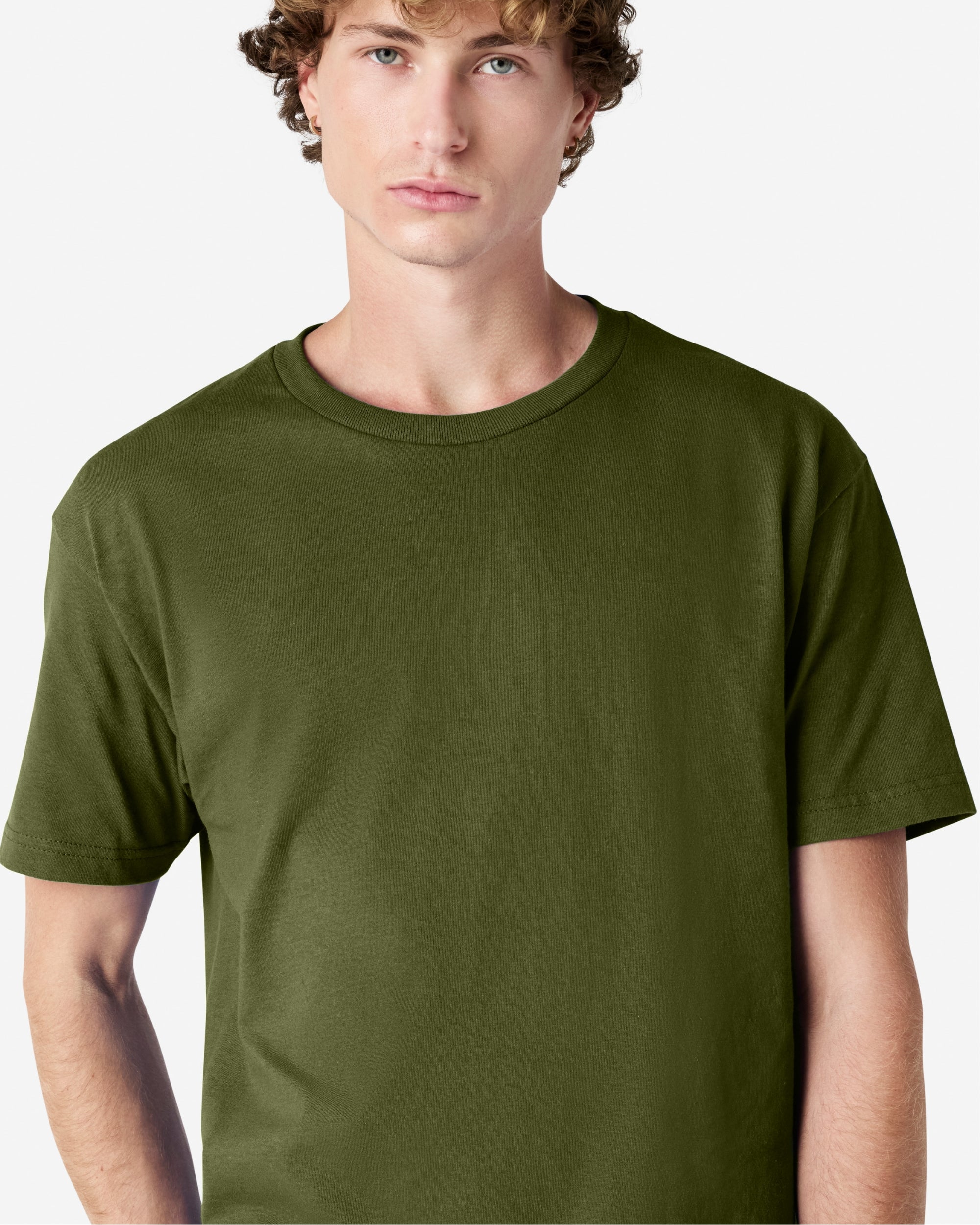 Male Model wearing a Military Green Heavyweight Unisex Short Sleeve Crew Neck Tee, paired with blue jeans, standing against a plain background (front pose) -military green