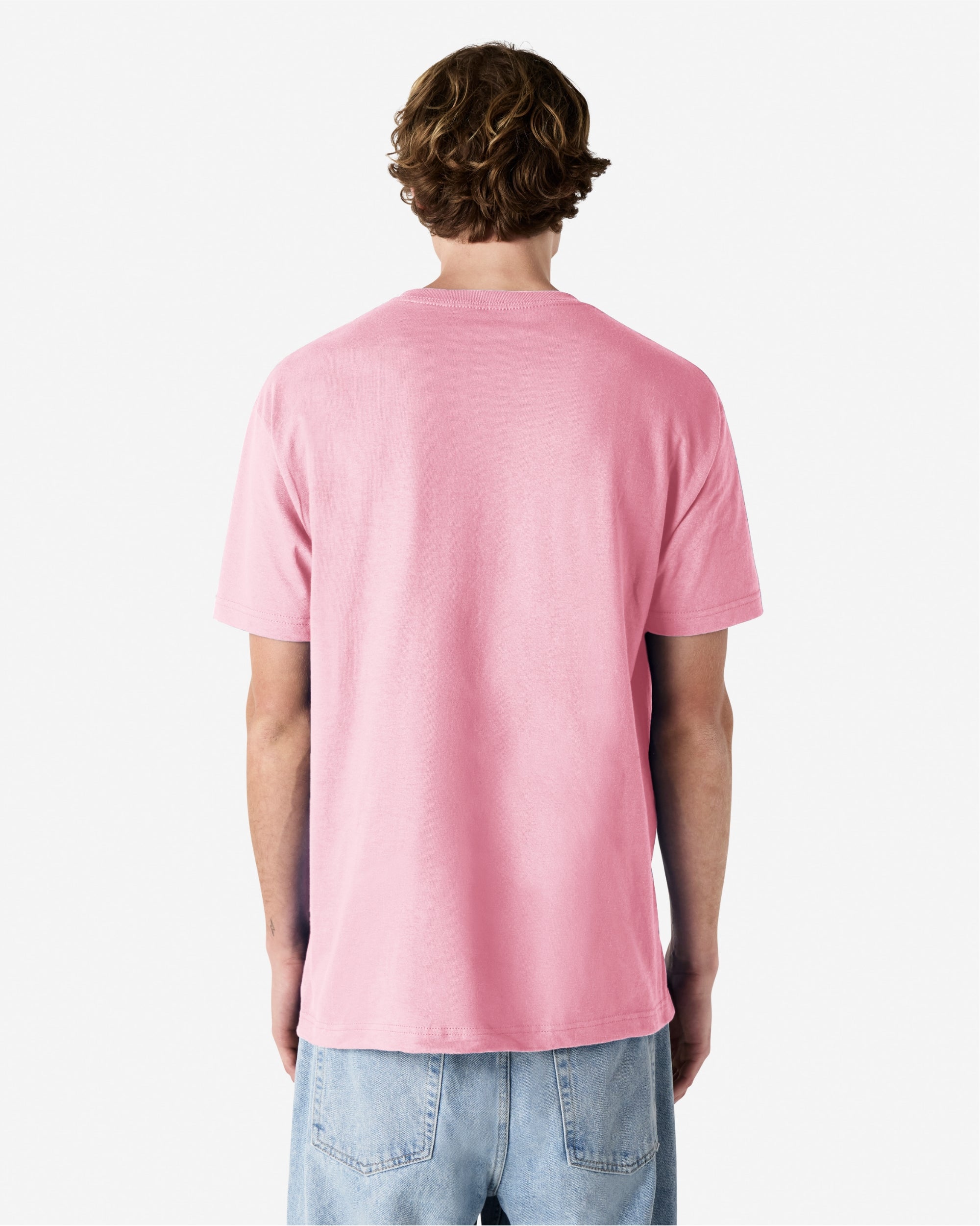 Male Model wearing a Pink Heavyweight Unisex Short Sleeve Crew Neck Tee, paired with blue jeans, standing against a plain background (back pose) -pink
