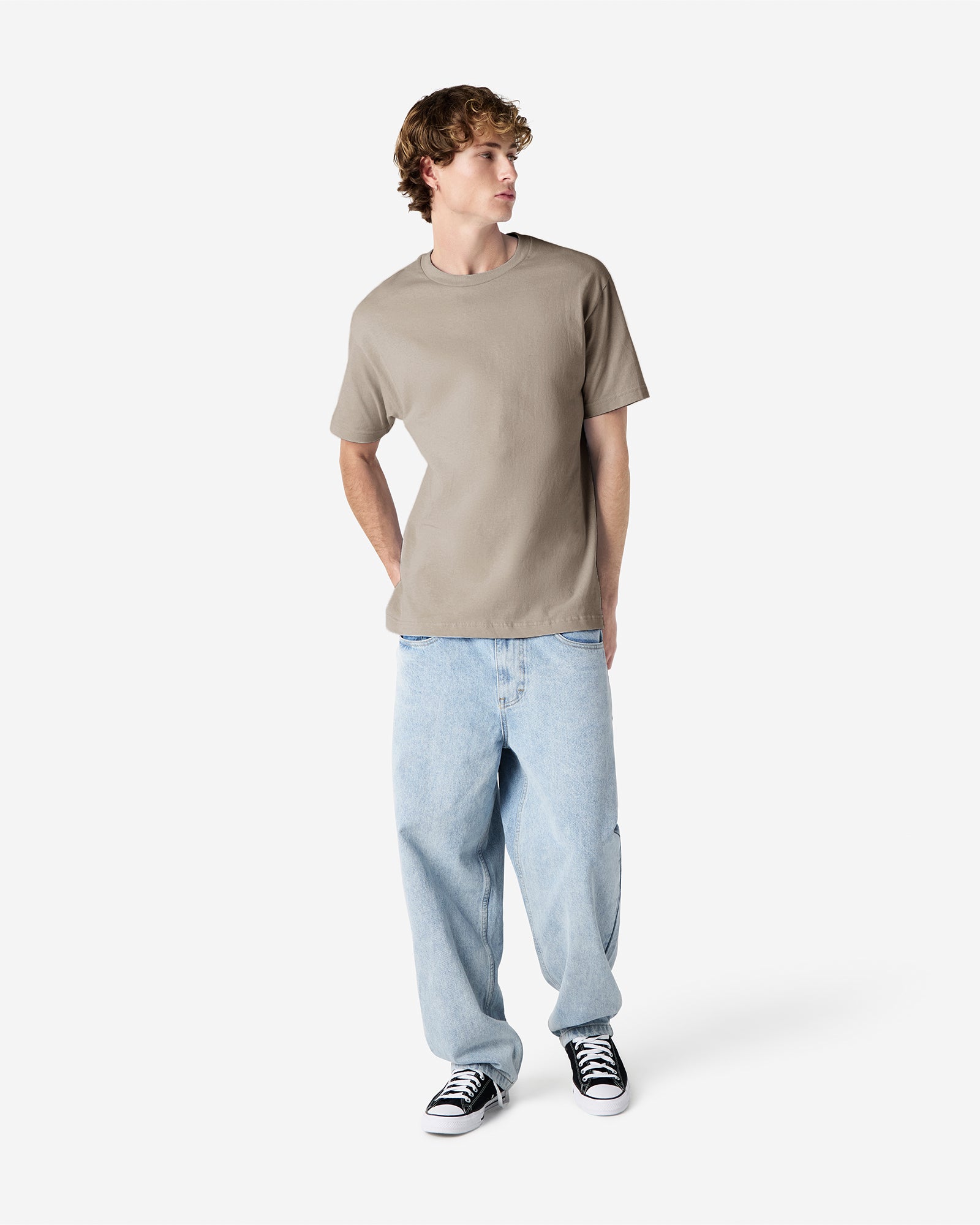 Male Model wearing a Slate Heavyweight Unisex Short Sleeve Crew Neck Tee, paired with blue jeans, standing against a plain background (front pose) -Slate
