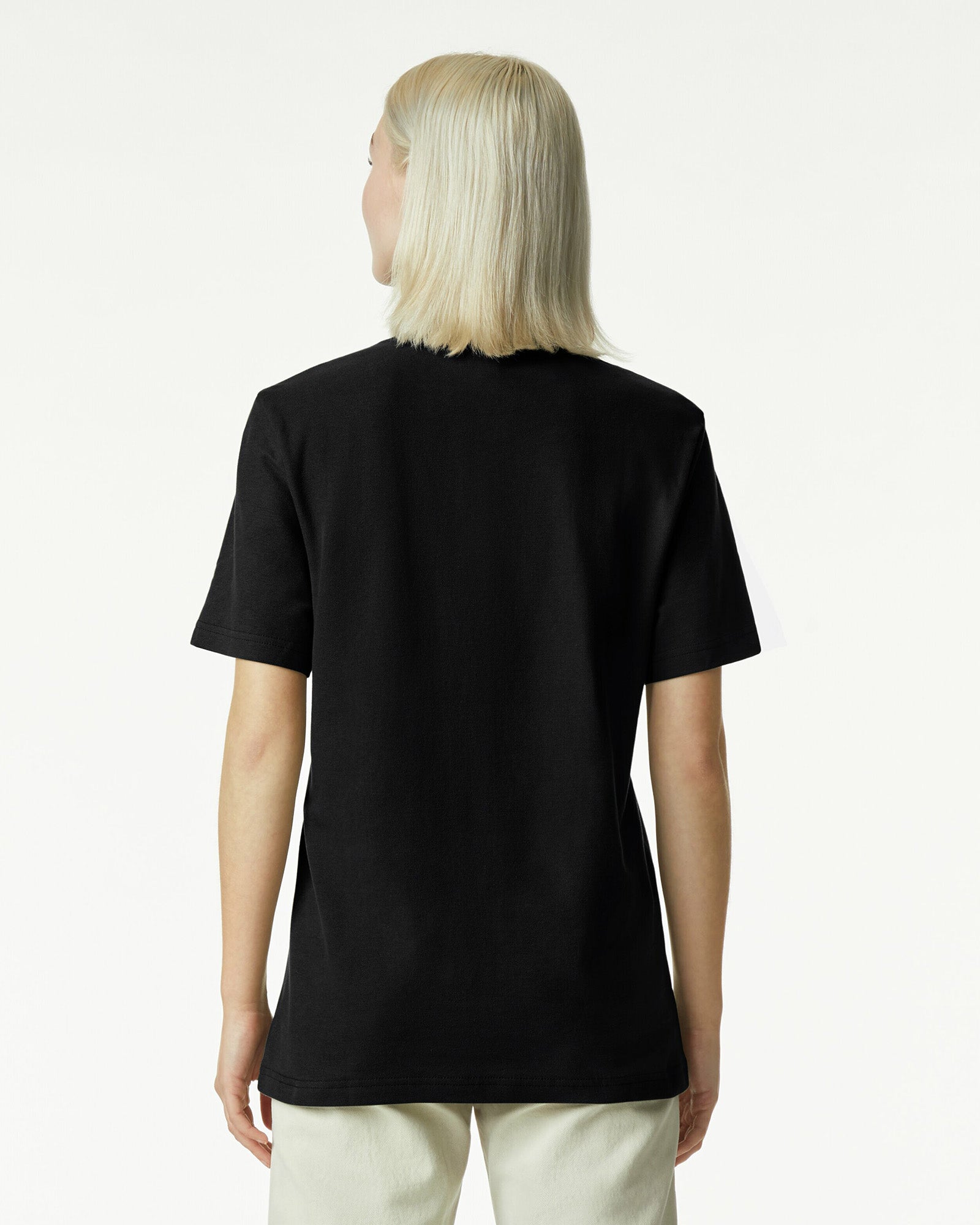 Female model wearing a Pique Unisex Mockneck Tee (back pose) -black
