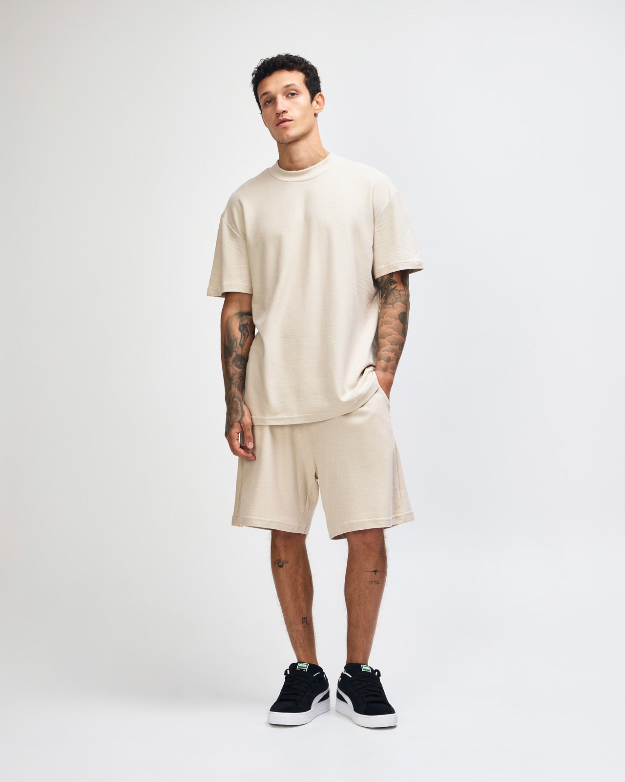 Male model wearing a Pique Unisex Mockneck Tee (front pose) -bone