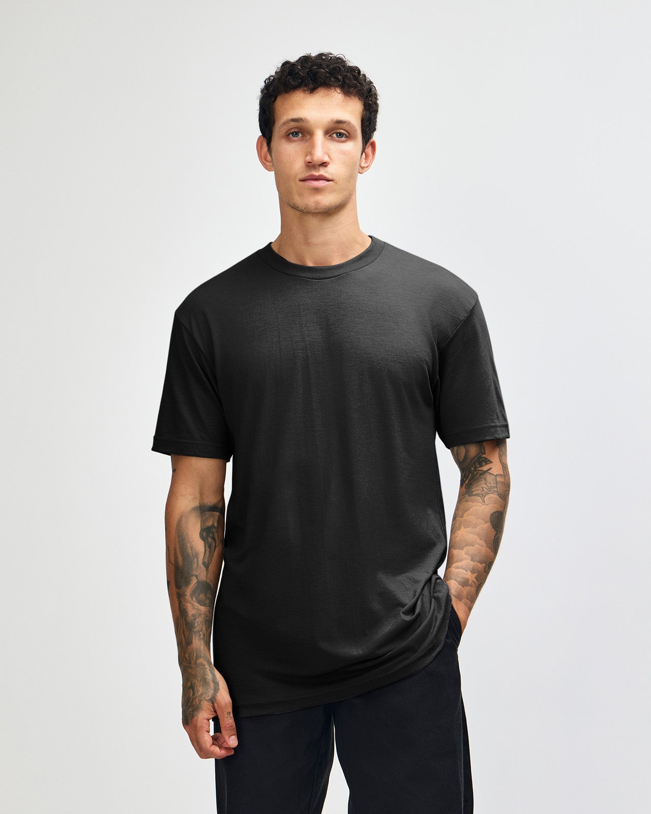 Male model wearing heather black colour CVC Unisex Short Sleeve Crew Neck Tee (front pose) -black