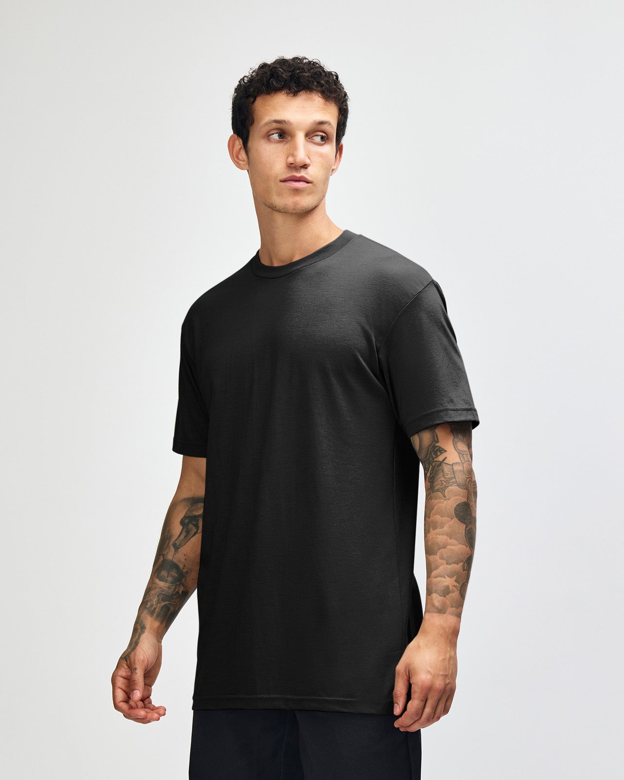 Male model wearing heather black colour CVC Unisex Short Sleeve Crew Neck Tee (front pose) -black