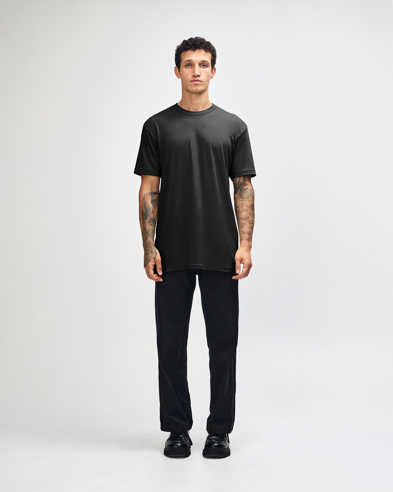 Male model wearing heather black colour CVC Unisex Short Sleeve Crew Neck Tee (front pose) -black