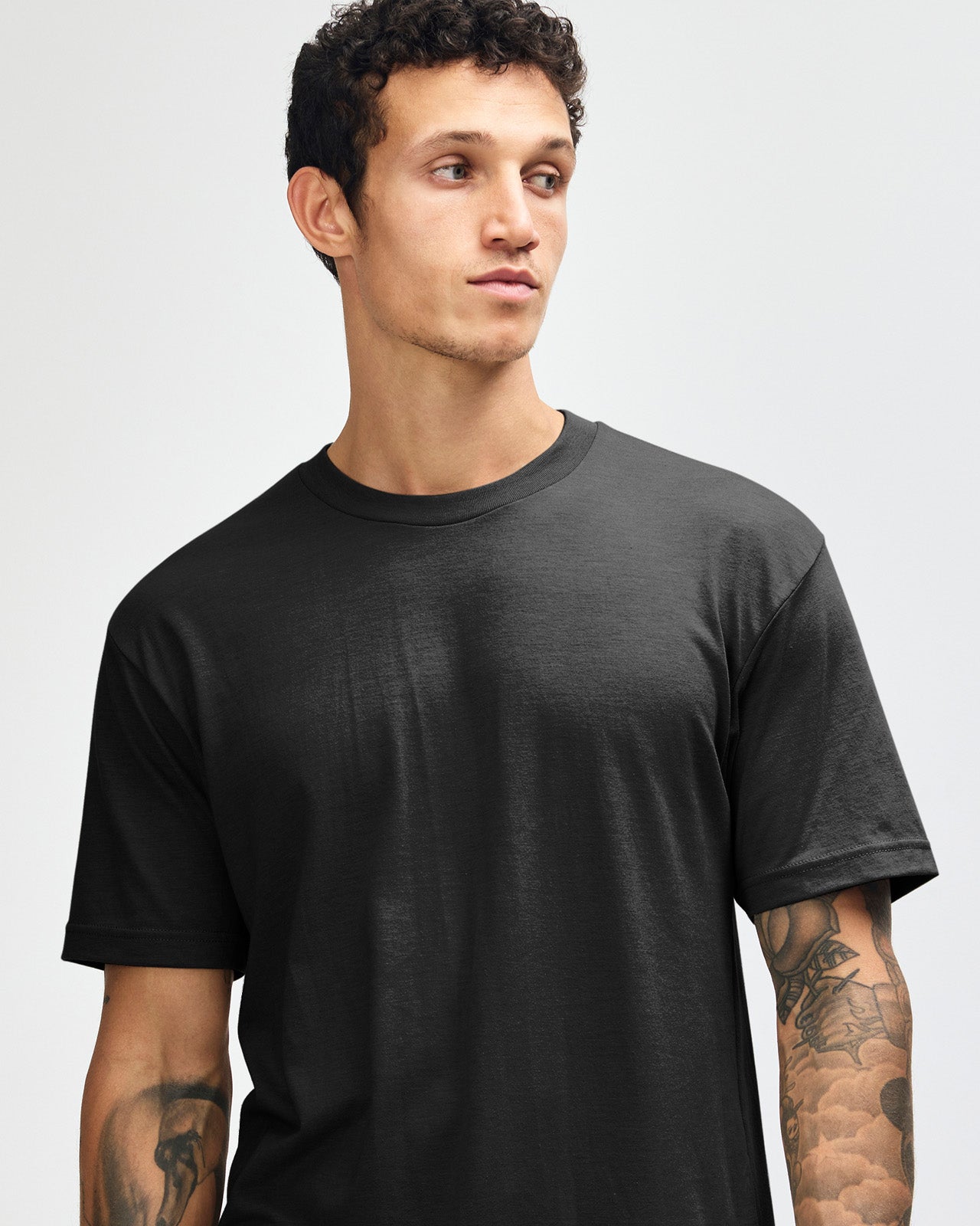 Male model wearing heather black colour CVC Unisex Short Sleeve Crew Neck Tee (front pose) -black