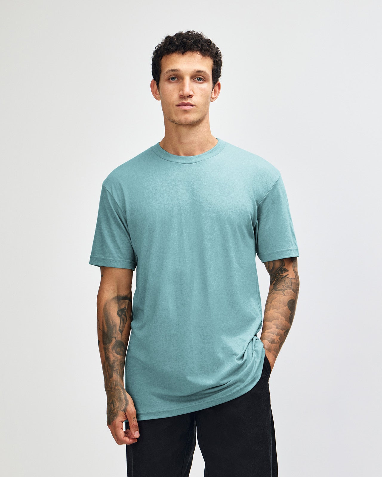 Male model wearing heather arctic colour CVC Unisex Short Sleeve Crew Neck Tee (front pose) -heather arctic