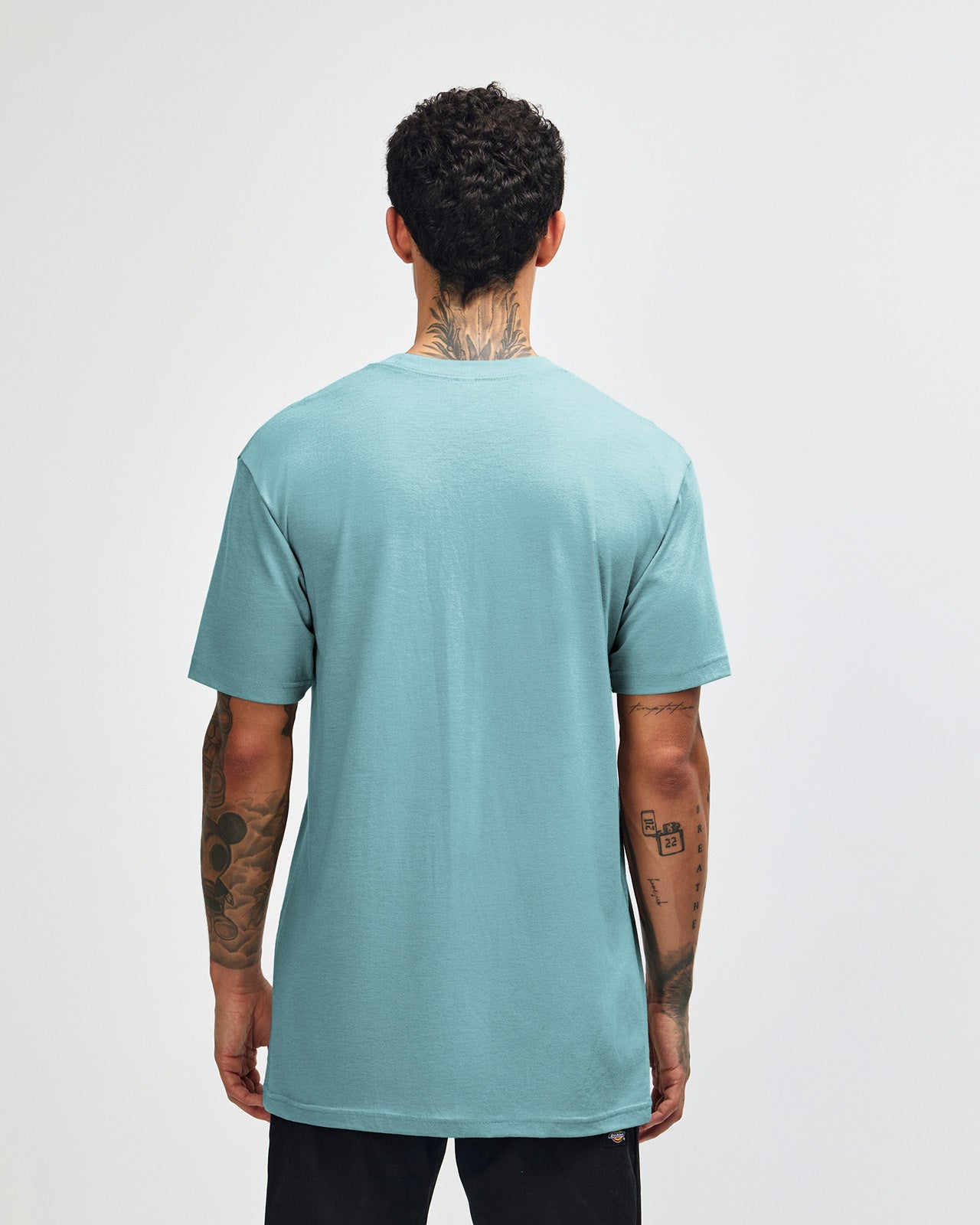 Male model wearing heather arctic colour CVC Unisex Short Sleeve Crew Neck Tee (back pose) -heather arctic
