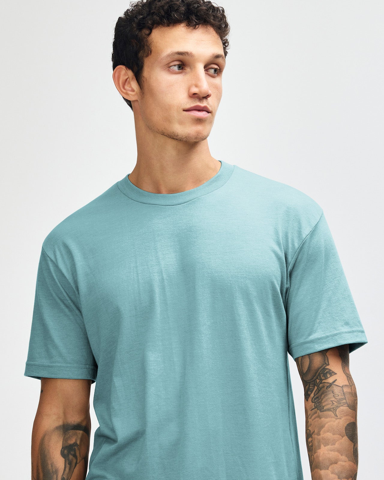 Male model wearing heather arctic colour CVC Unisex Short Sleeve Crew Neck Tee (front pose) -heather arctic