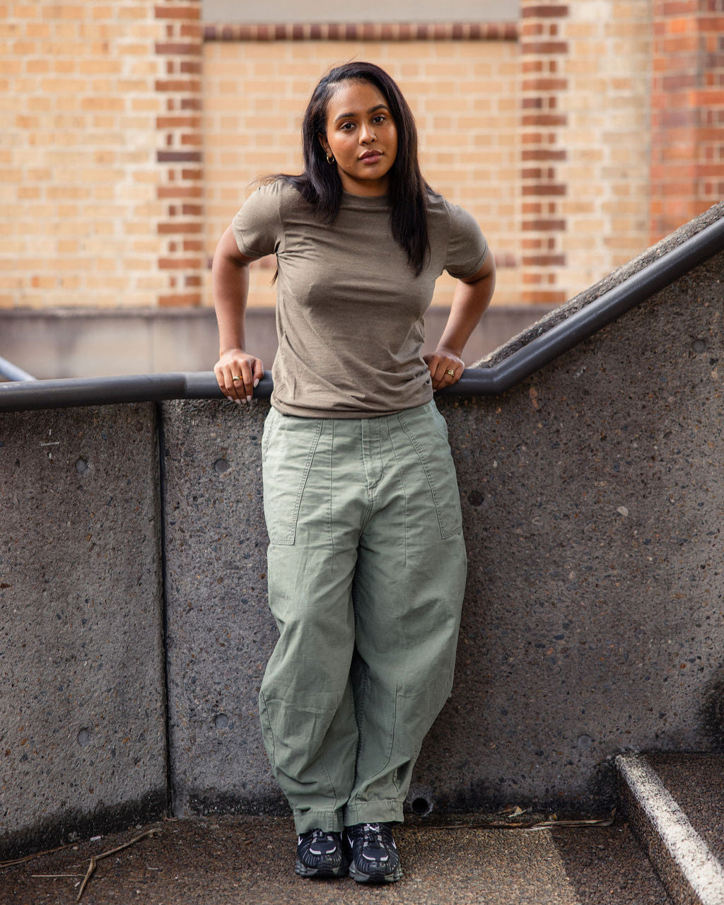 Female model wearing heather army colour CVC Unisex Short Sleeve Crew Neck Tee (back pose) - heather army