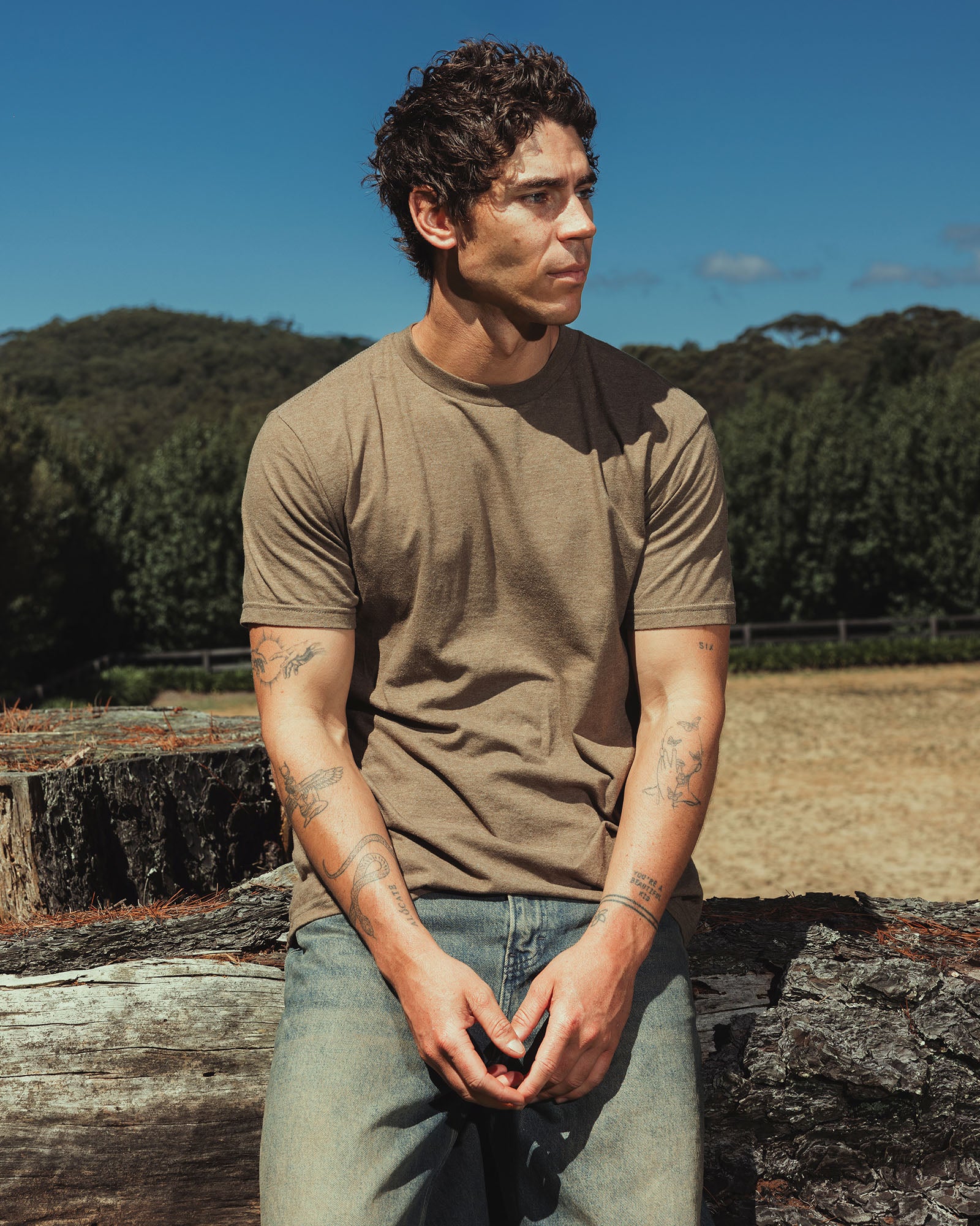 Male model wearing heather army colour CVC Unisex Short Sleeve Crew Neck Tee (front pose) -heather army