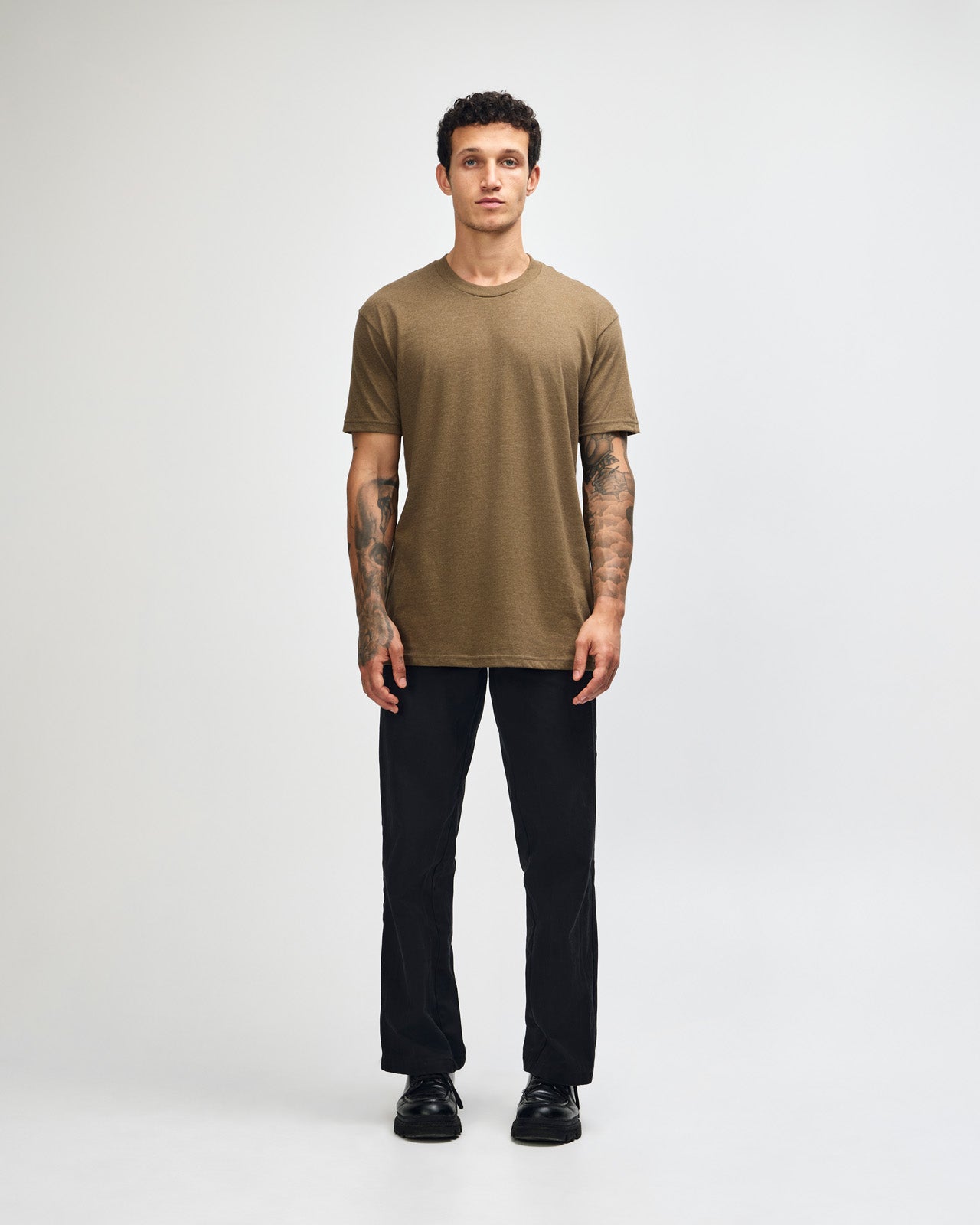 Male model wearing heather army colour CVC Unisex Short Sleeve Crew Neck Tee (front pose) -heather army