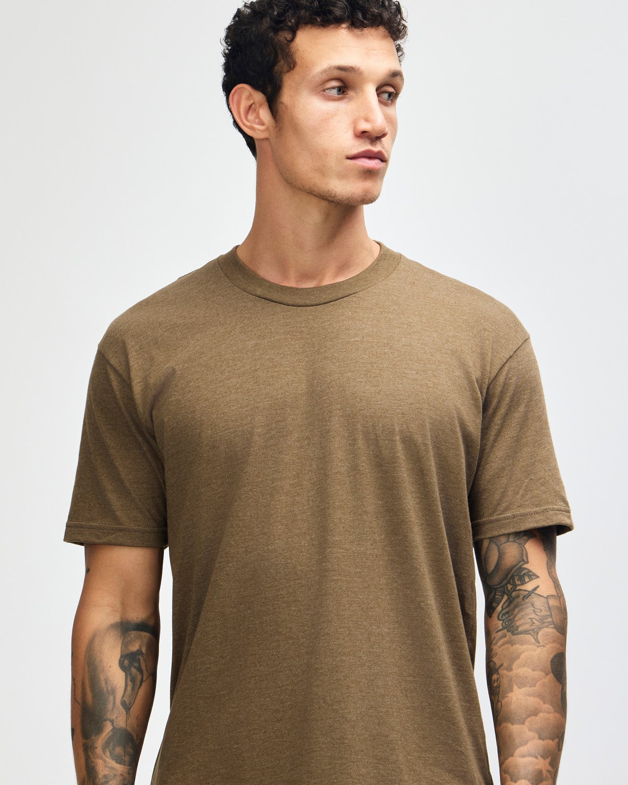 Male model wearing heather army colour CVC Unisex Short Sleeve Crew Neck Tee (front pose) -heather army
