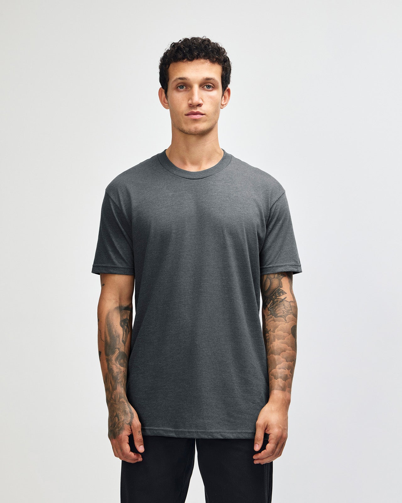 Male model wearing heather asphalt colour CVC Unisex Short Sleeve Crew Neck Tee (front pose) -heather asphalt