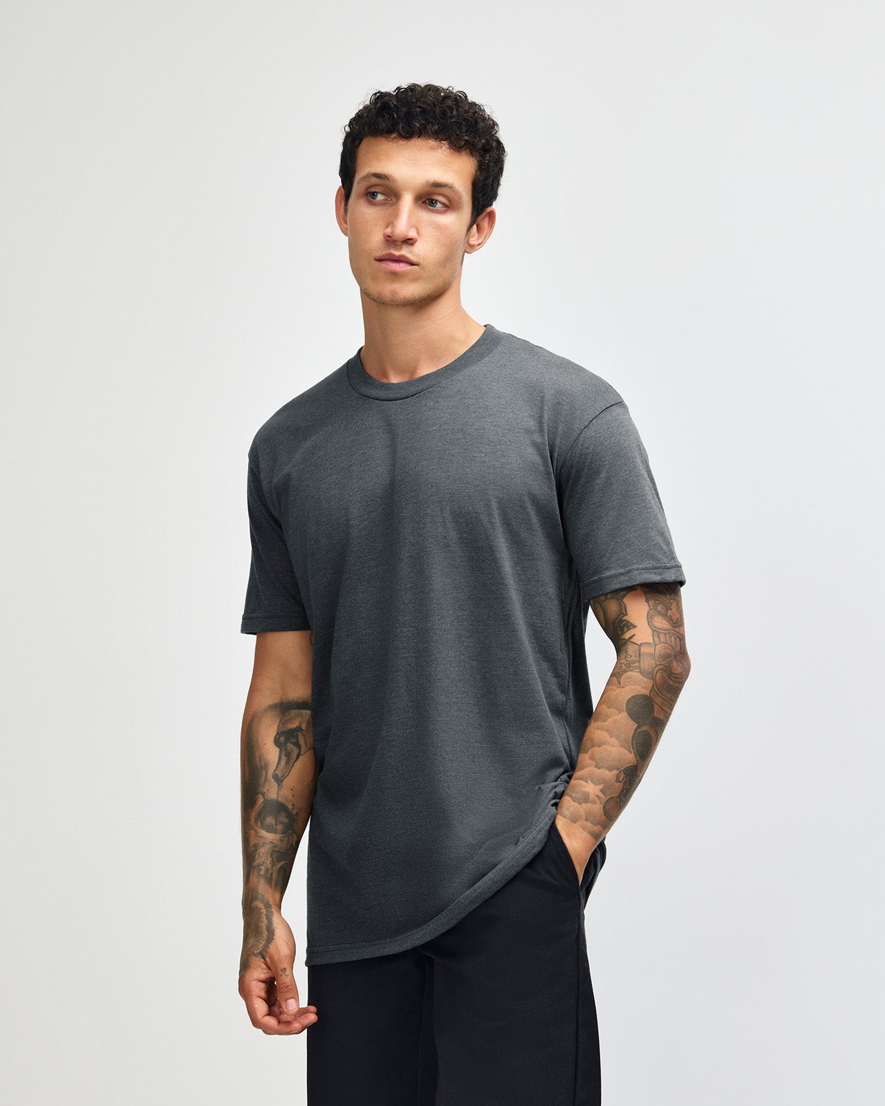 Male model wearing heather asphalt colour CVC Unisex Short Sleeve Crew Neck Tee (front pose) -heather asphalt