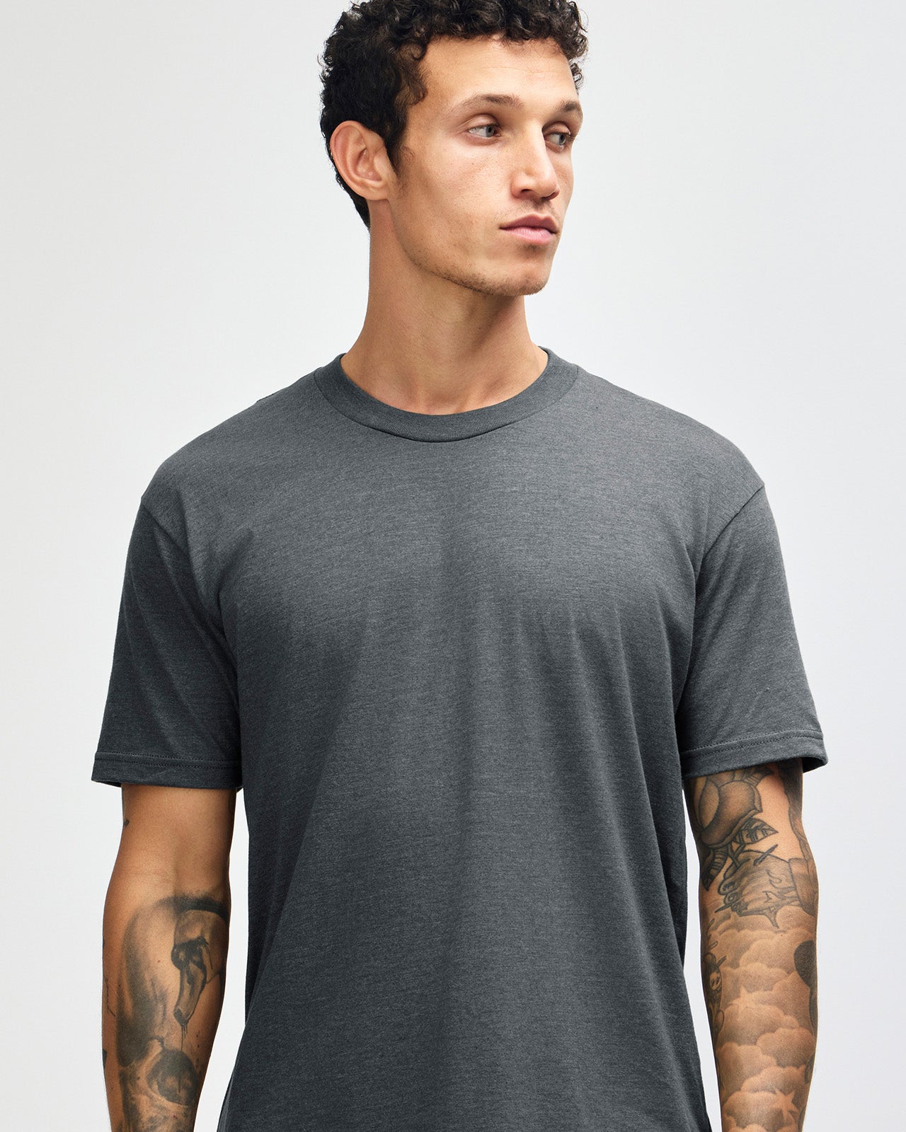Male model wearing heather asphalt colour CVC Unisex Short Sleeve Crew Neck Tee (front pose) -heather asphalt