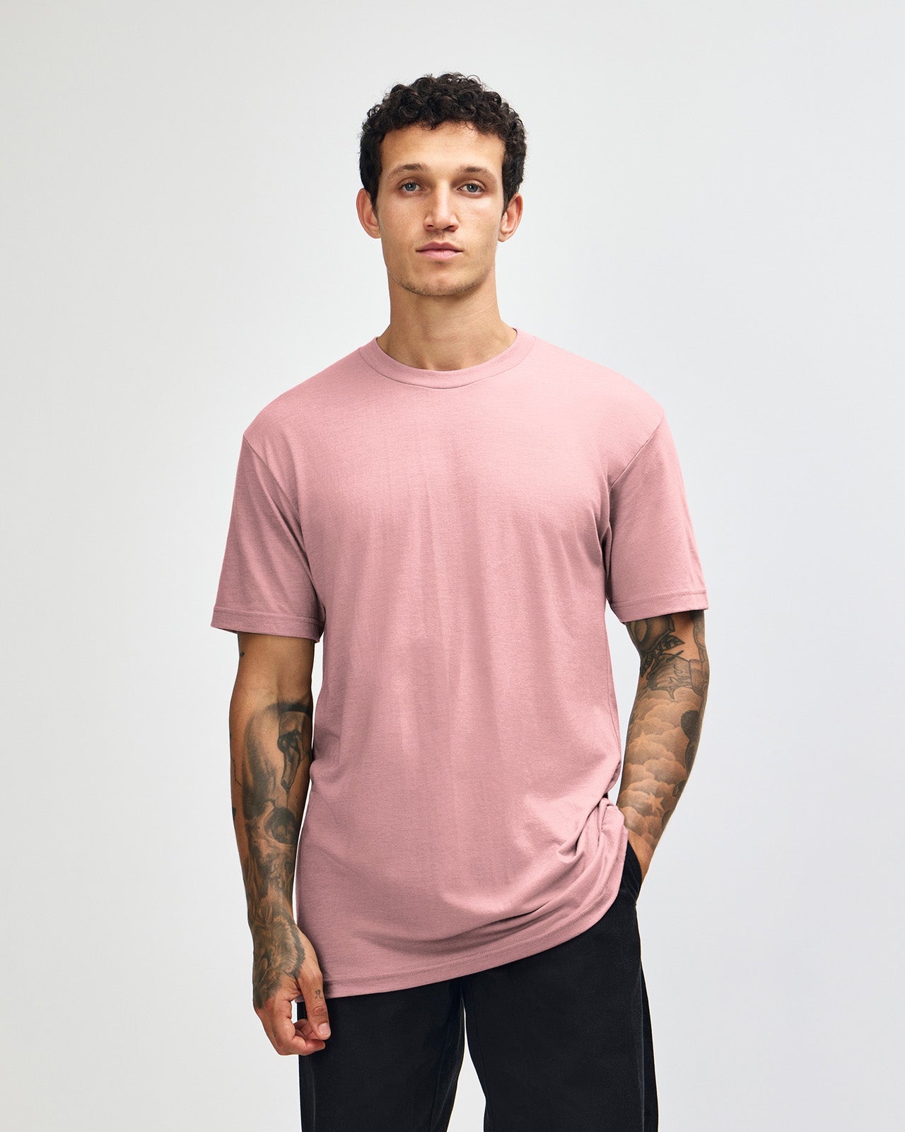 Male model wearing heather blush colour CVC Unisex Short Sleeve Crew Neck Tee (front pose) -heather blush
