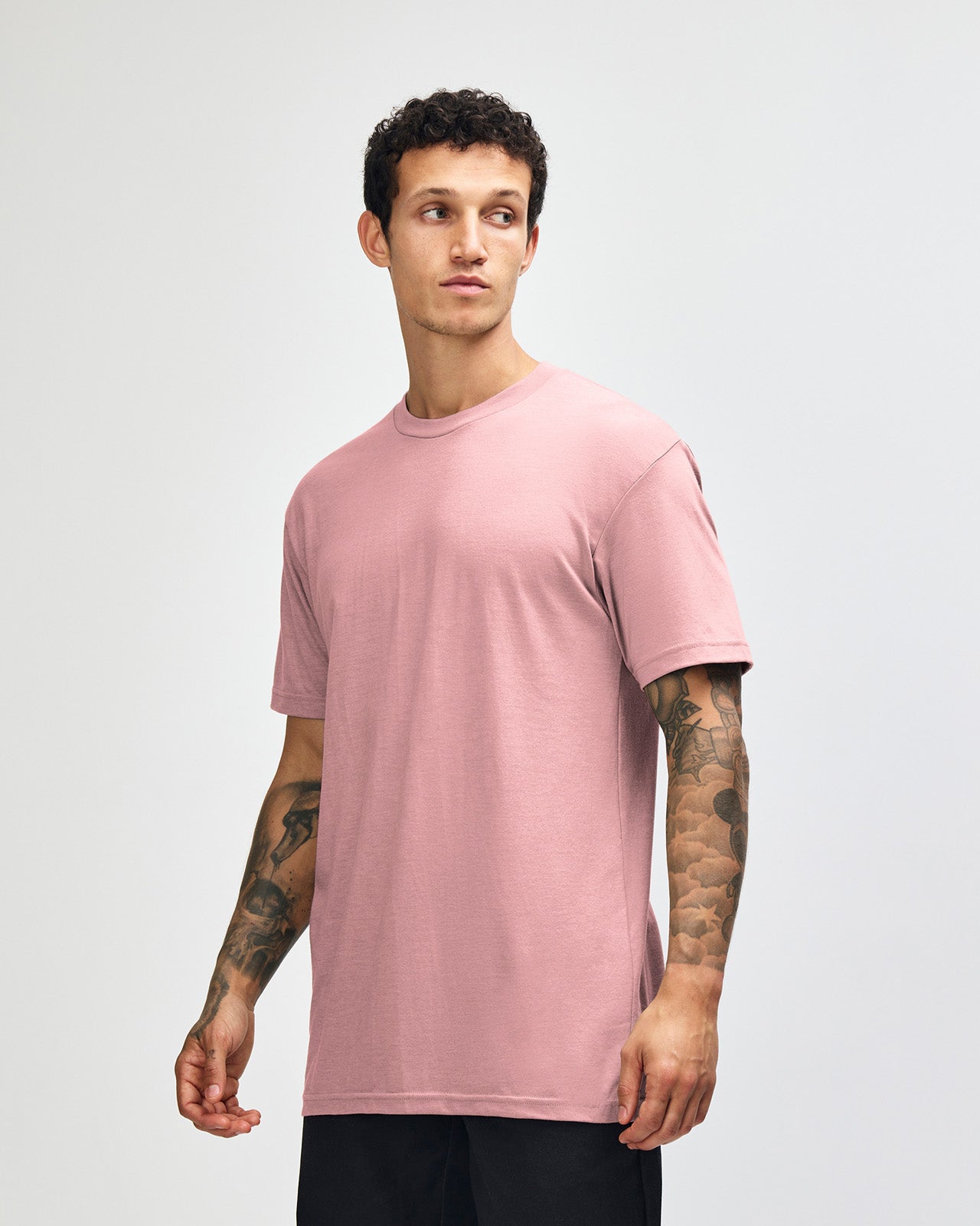 Male model wearing heather blush colour CVC Unisex Short Sleeve Crew Neck Tee (front pose) -heather blush
