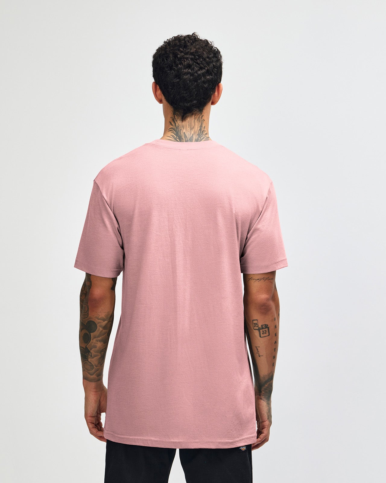 Male model wearing heather blush colour CVC Unisex Short Sleeve Crew Neck Tee (back pose) -heather blush