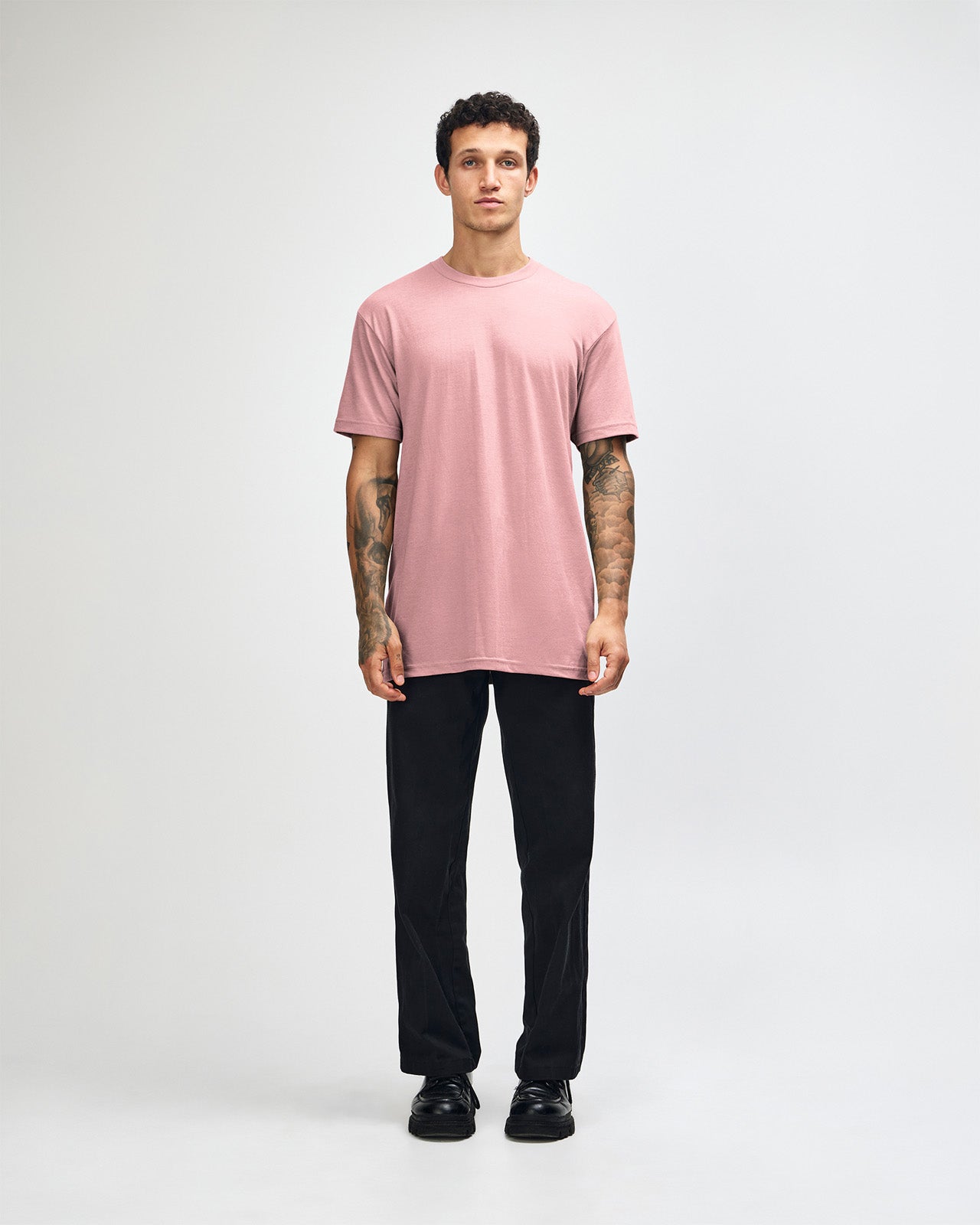 Male model wearing heather blush colour CVC Unisex Short Sleeve Crew Neck Tee (front pose) -heather blush