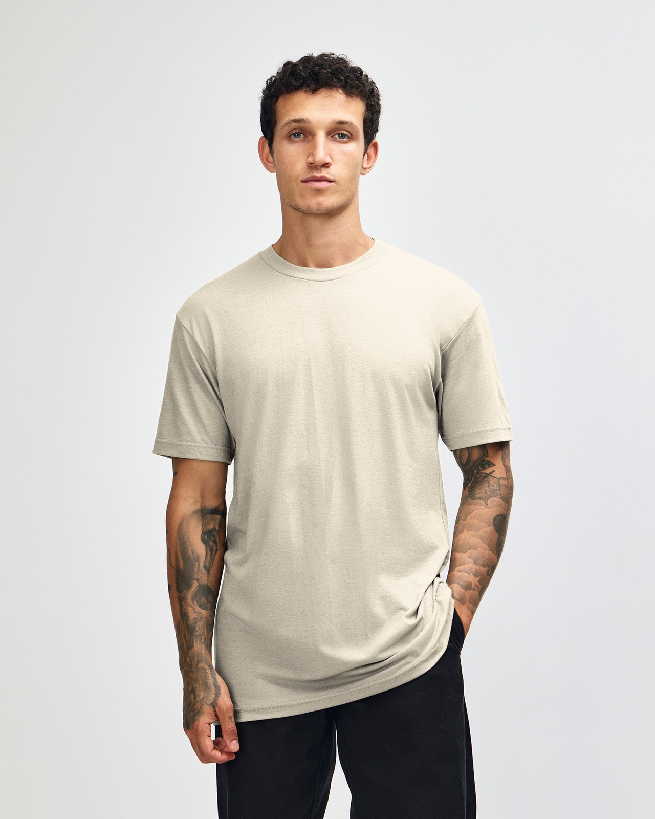 Male model wearing heather bone colour CVC Unisex Short Sleeve Crew Neck Tee (front pose) -heather bone